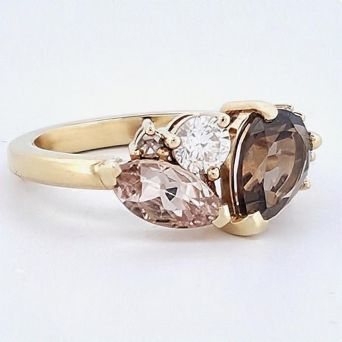 Yellow gold ring featuring a large oval whiskey quartz, pear-shaped morganite, champagne diamond and white diamond accents.