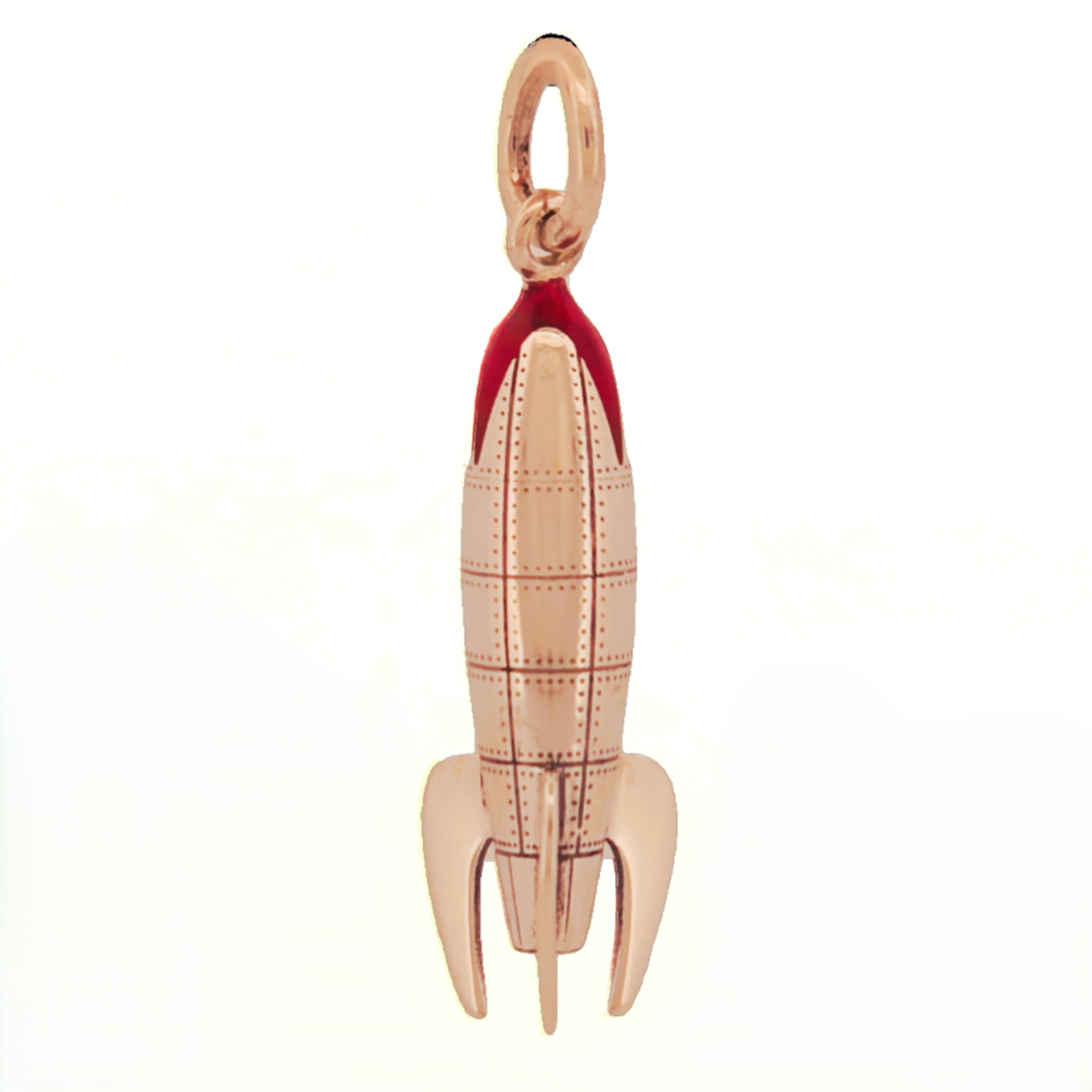Sterling silver rocketship pendant with rivet panel detailing, red enamel nose cone, and three sculpted fins in retro sci-fi style.