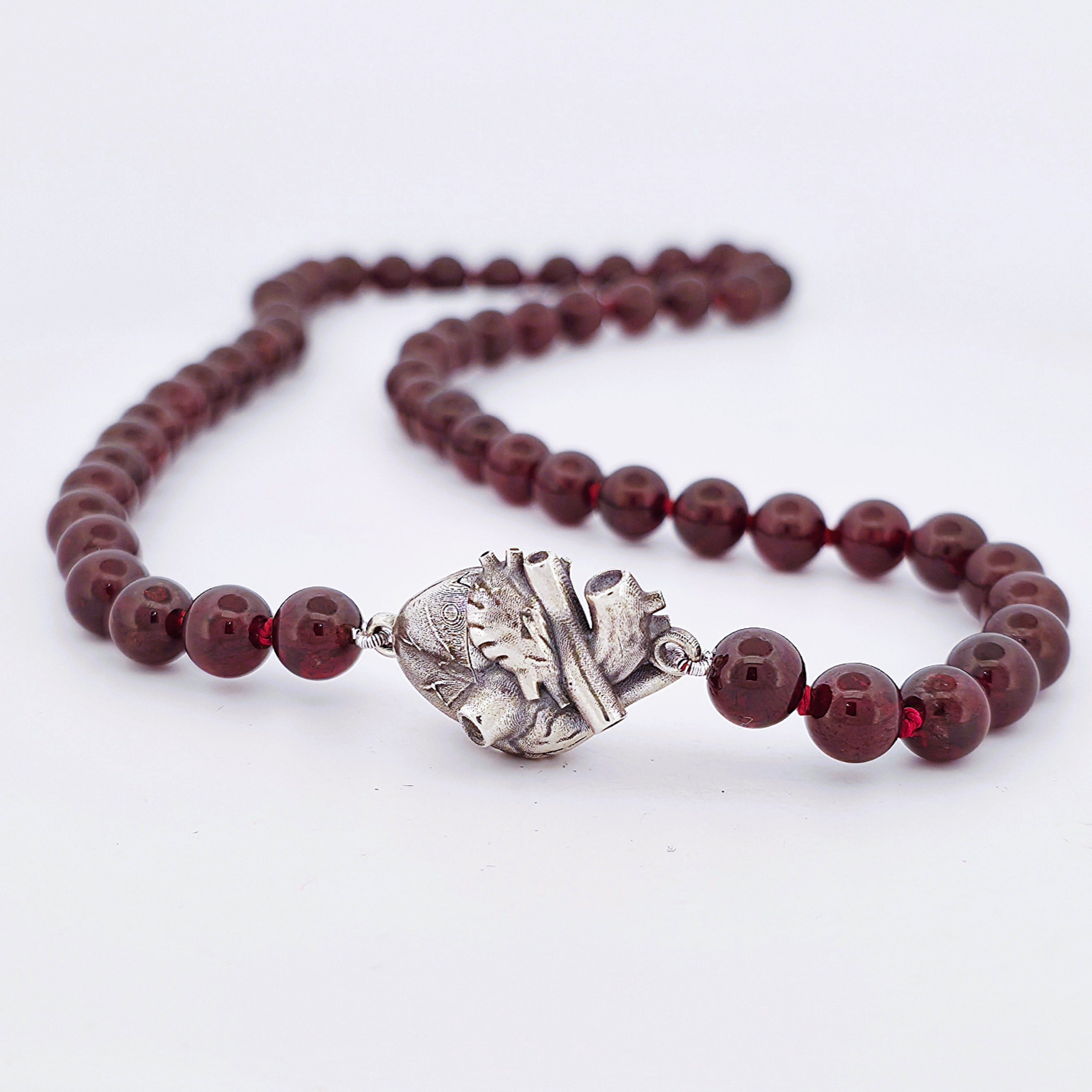 Sterling Silver oxidised magnetic anatomical heart pendant necklace on a single strand of round garnets