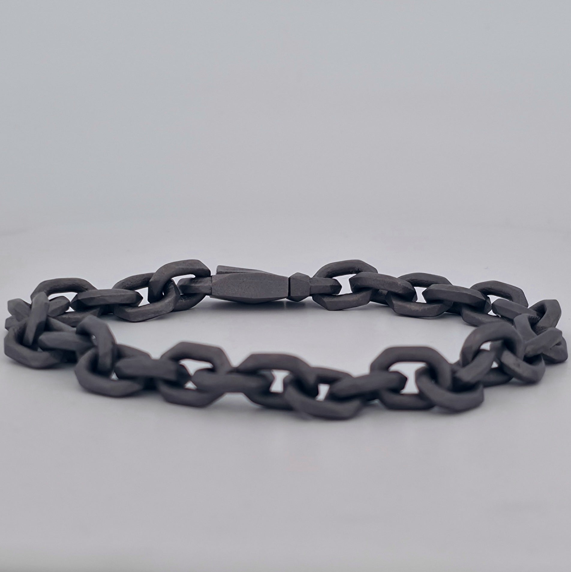 Tantalum chain bracelet with interlocking faceted links and a custom tantalum clasp