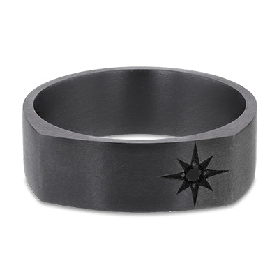 Front view of a 7mm wide Tantalum signet band with a matte brushed finish, featuring a star-set round black diamond. The ring has a flat outer profile with softly curved edges, combining the high density and muted grey tone of Tantalum with the minimalist contrast of a single dark gemstone. A contemporary, durable design ideal for modern commitment jewellery.