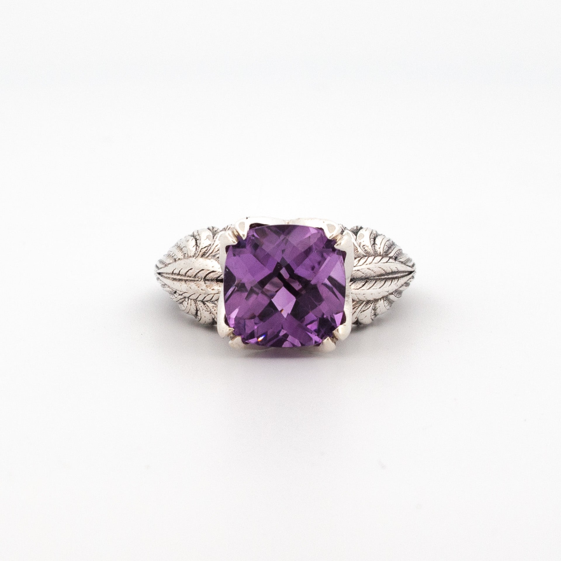 Sterling silver ring with 10mm cushion-cut amethyst and detailed sculpted leaf band.