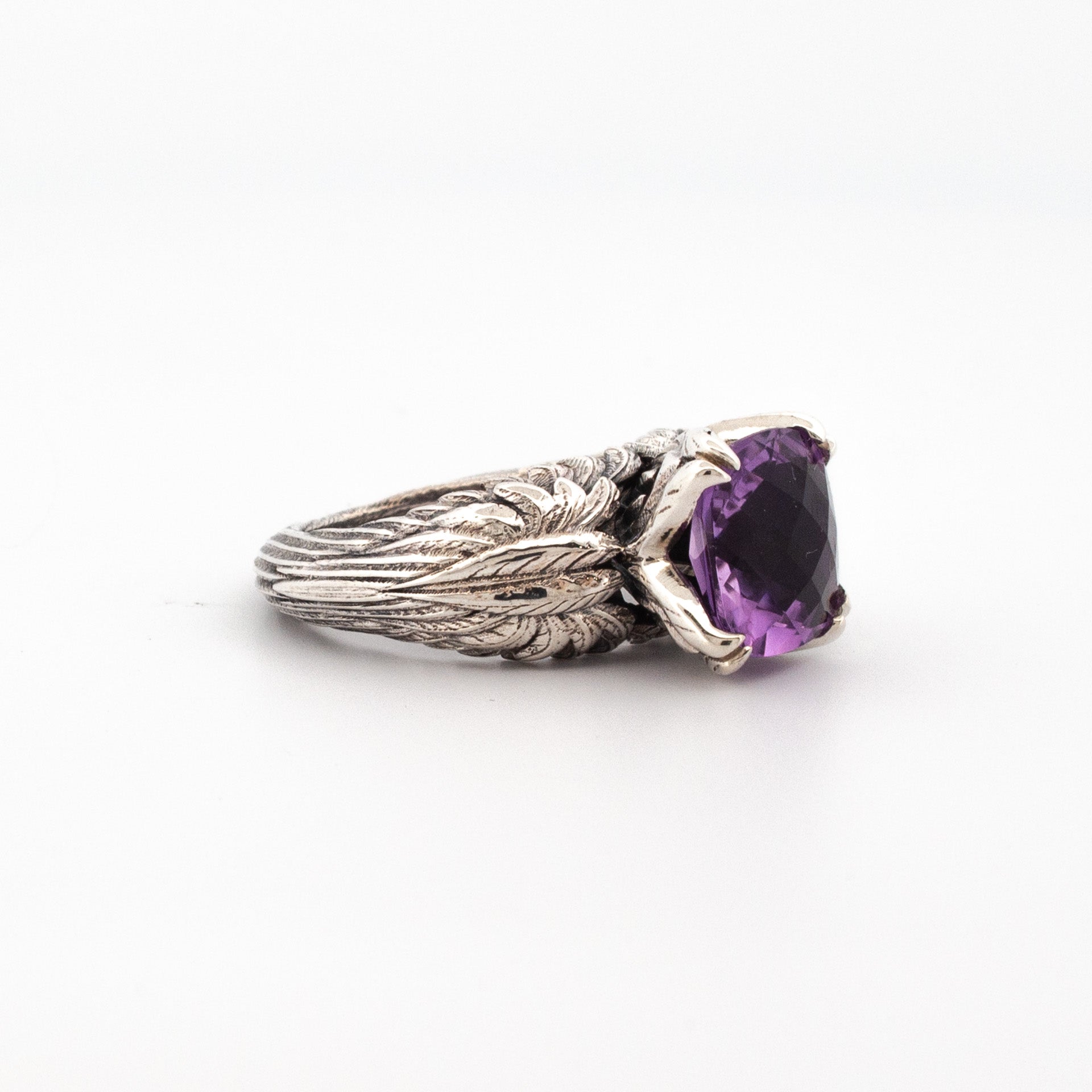Sterling silver ring with 10mm cushion-cut amethyst and detailed sculpted leaf band.