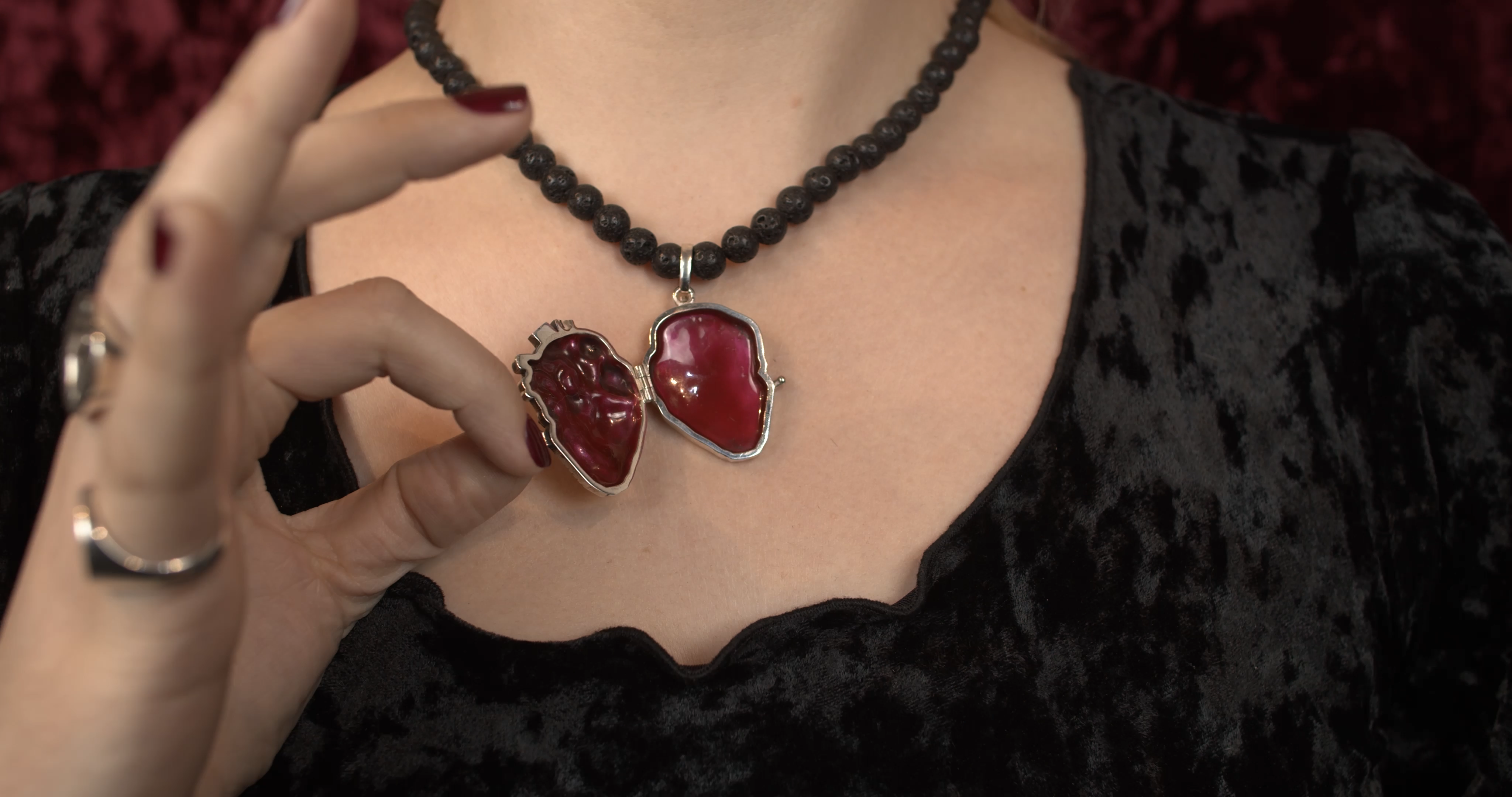 Sterling silver anatomical heart locket pendant with deep red enamel interior on black beaded necklace