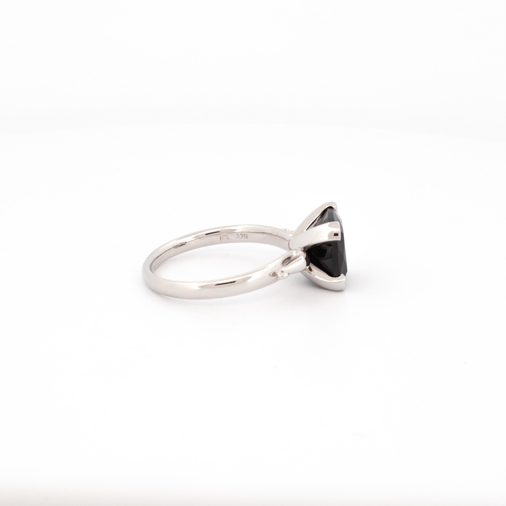 9ct white gold ring with cushion cut black spinel, four claw setting, polished band, handmade solitaire design