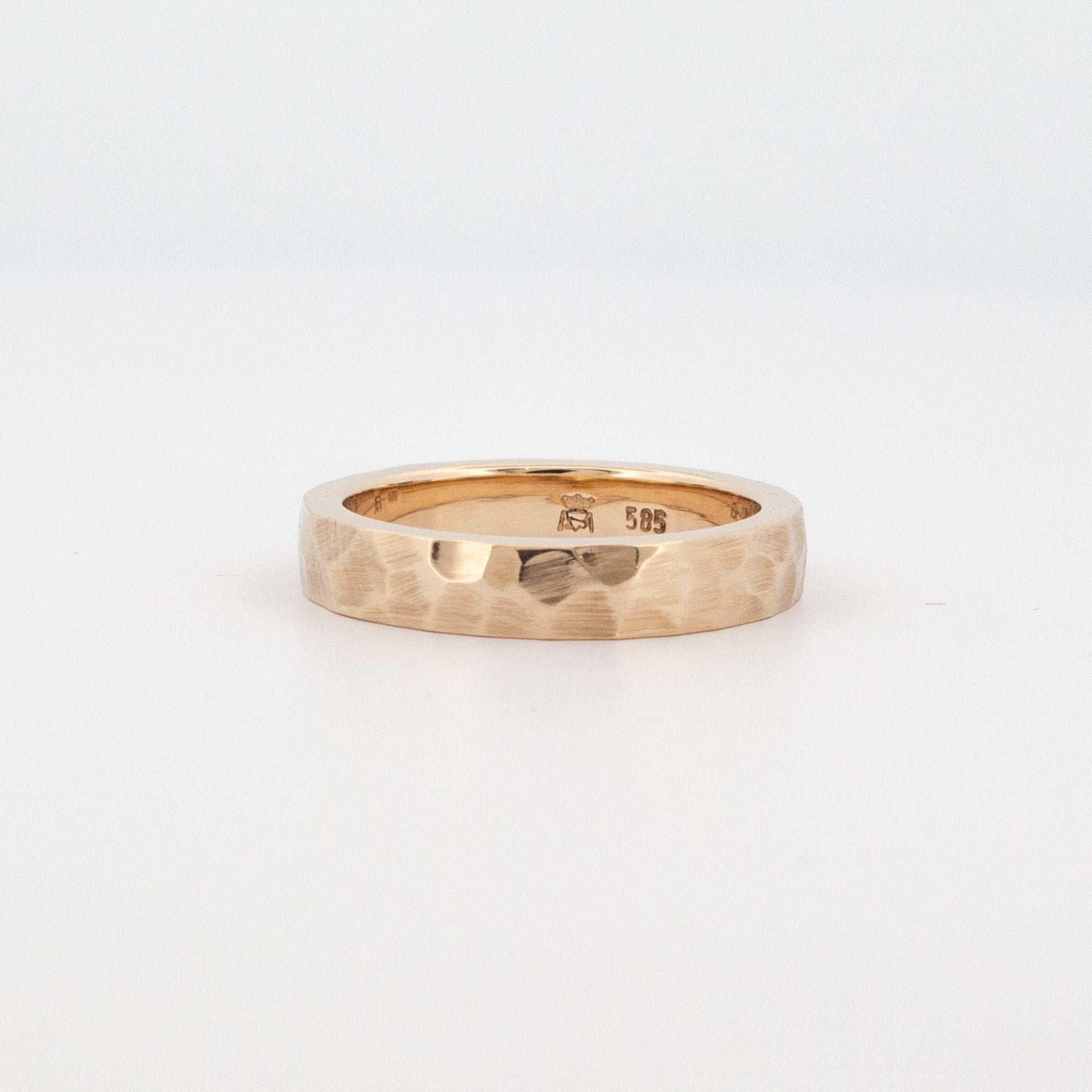 14ct yellow gold ring with faceted hammered finish and softly squared profile, featuring hallmark stamps inside band.