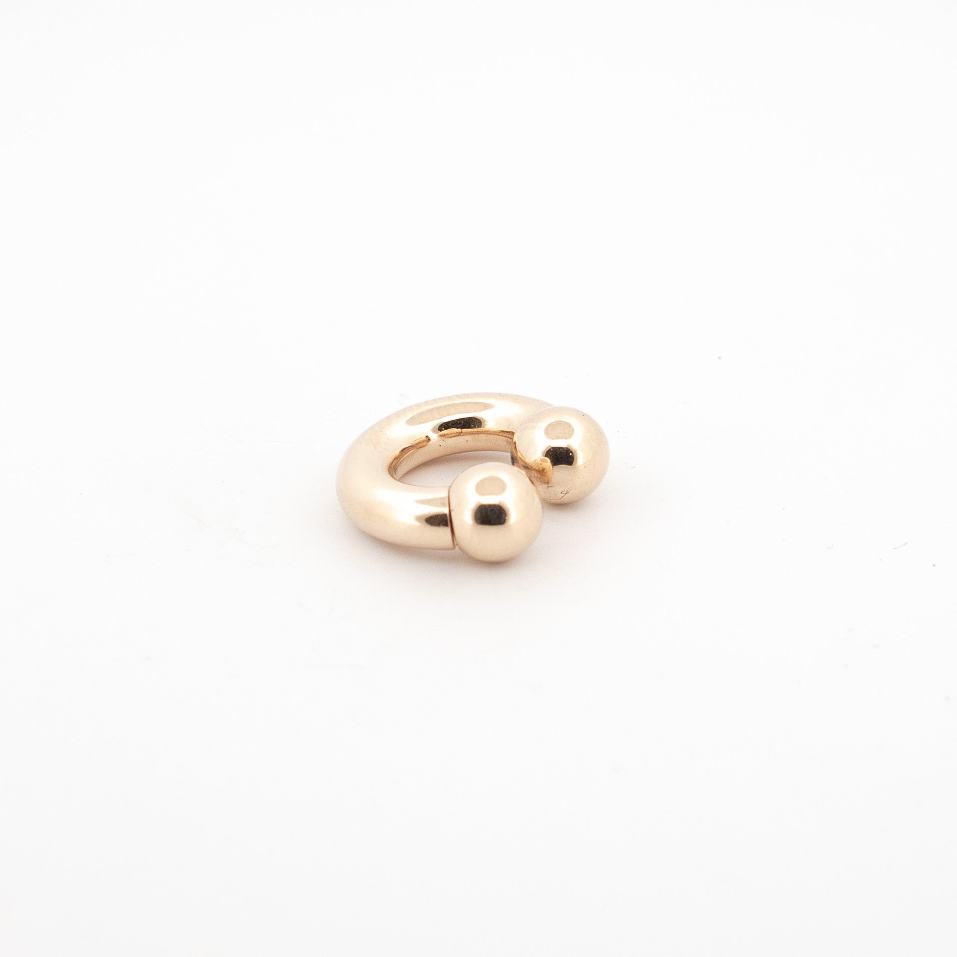 custom made 9ct gold septum piercing jewellery, with a golden finish aand screwball opening