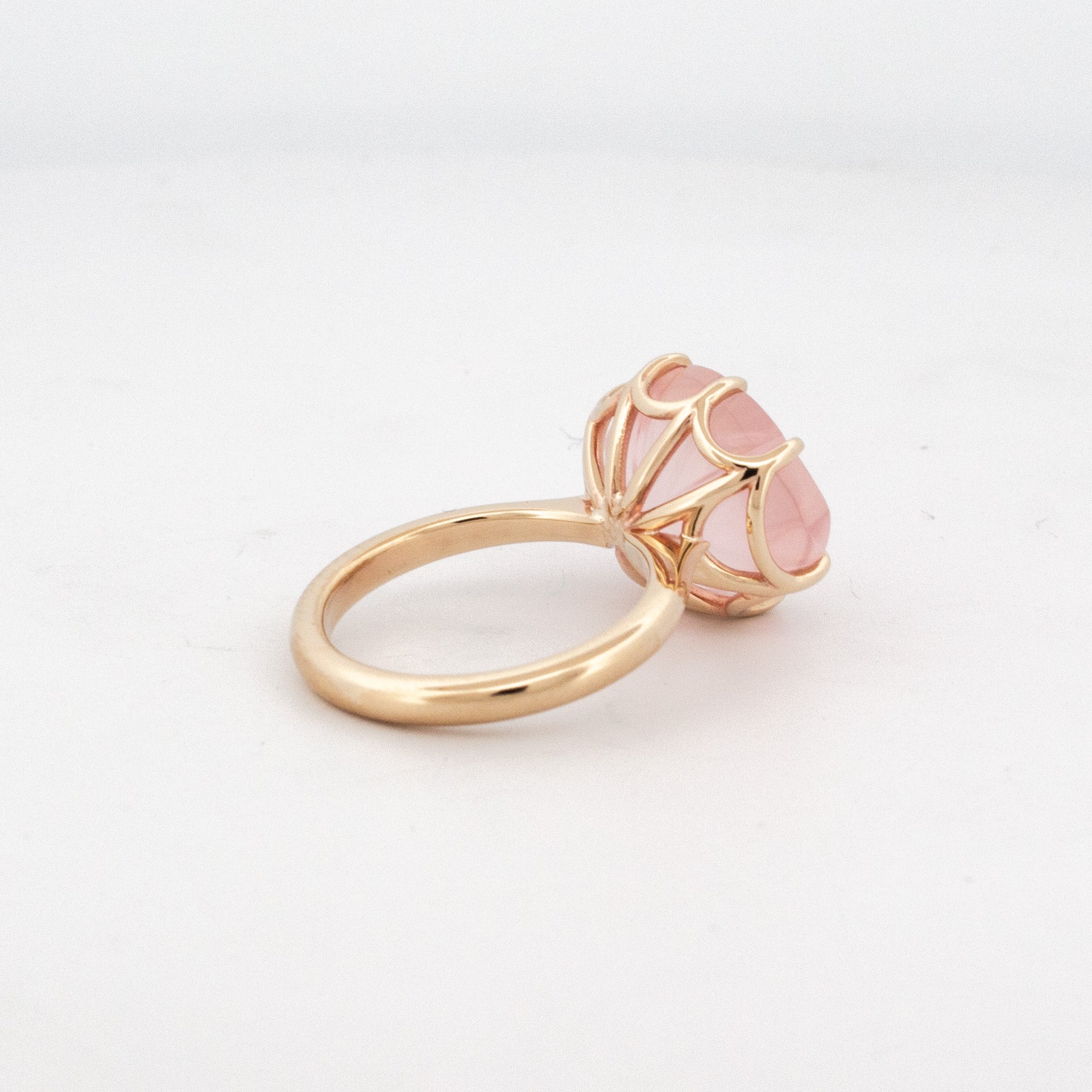 back view of 9ct yellow gold ring with custom-cut rose quartz in floral faceted design and matching detailed basket setting.