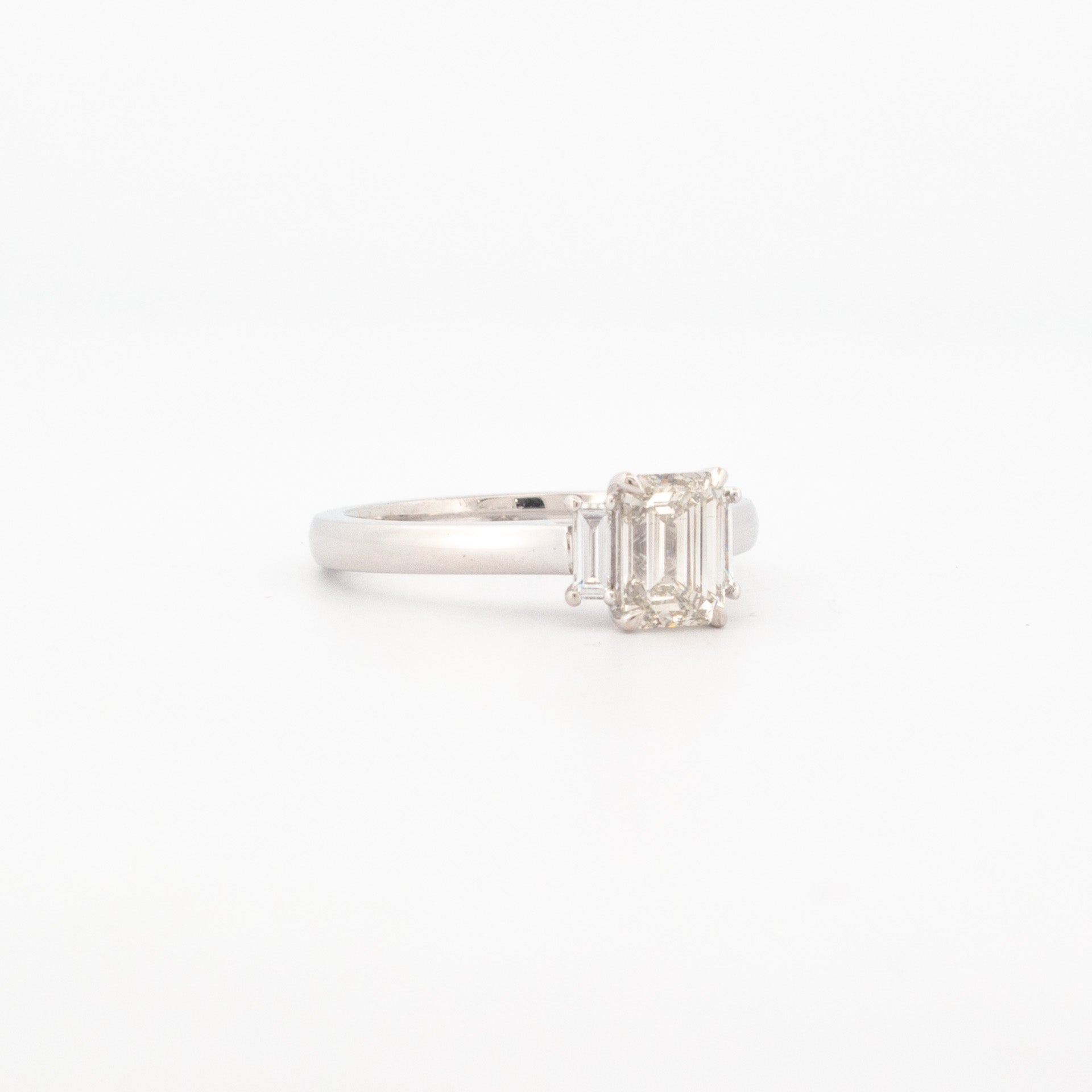 1ct emerald cut diamond ring with tapered baguette side stones in 18ct white gold.