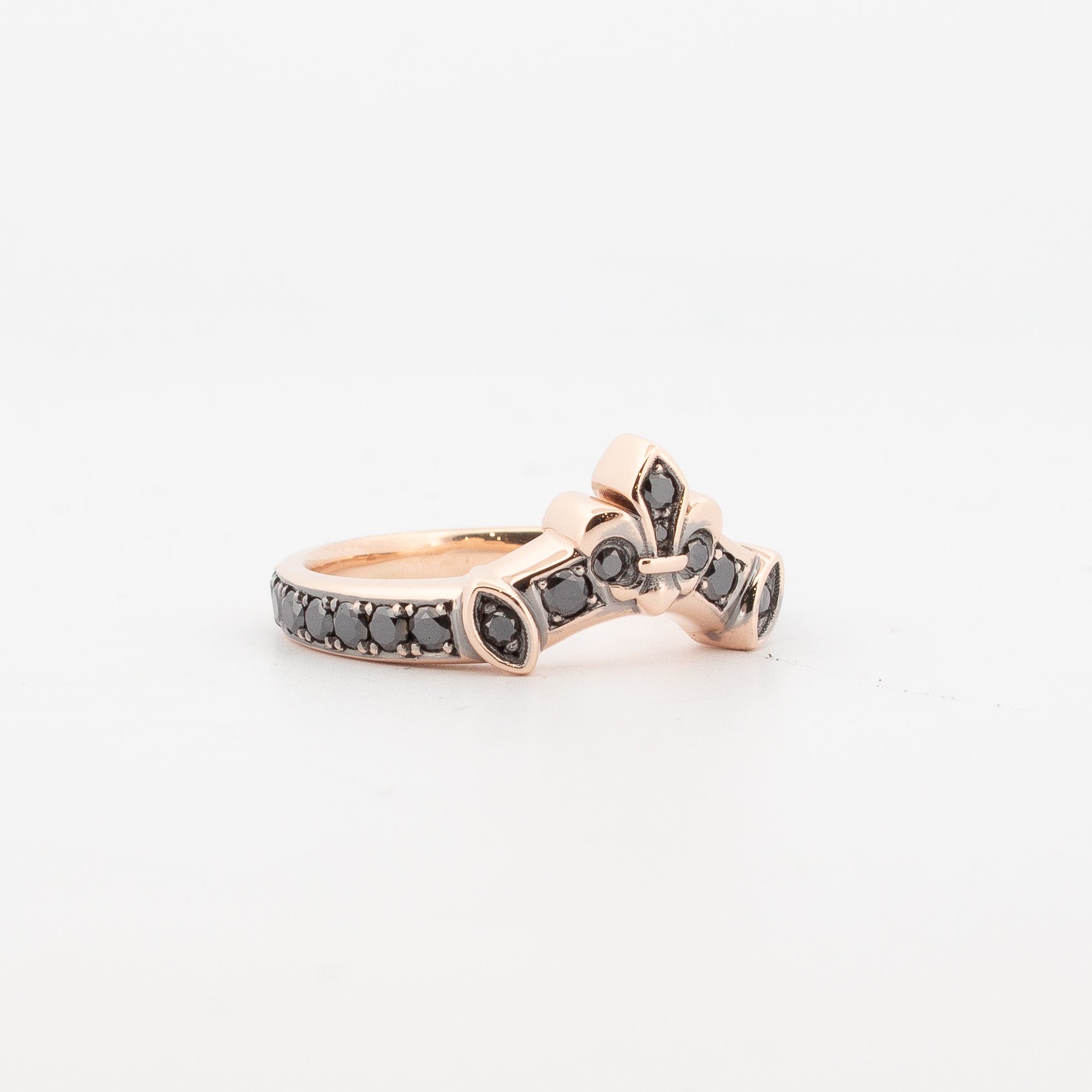 9ct rose gold fitted ring set with round black diamonds and black rhodium detailing, featuring a fleur-de-lis motif; designed to pair with the Medieval Treasure Garnet Ring.