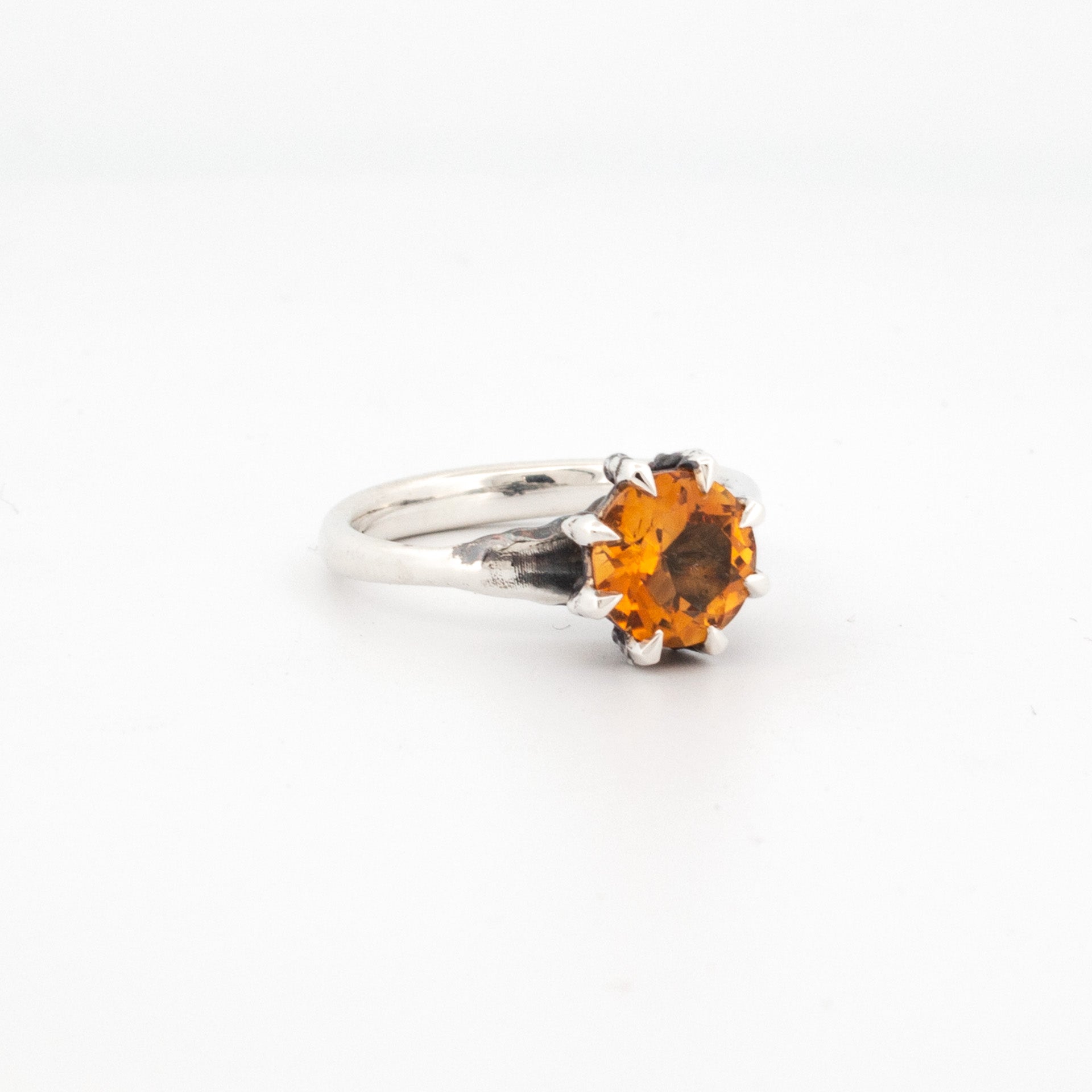 8mm round citrine claw-set in sterling silver talon-style setting with textured silver band.