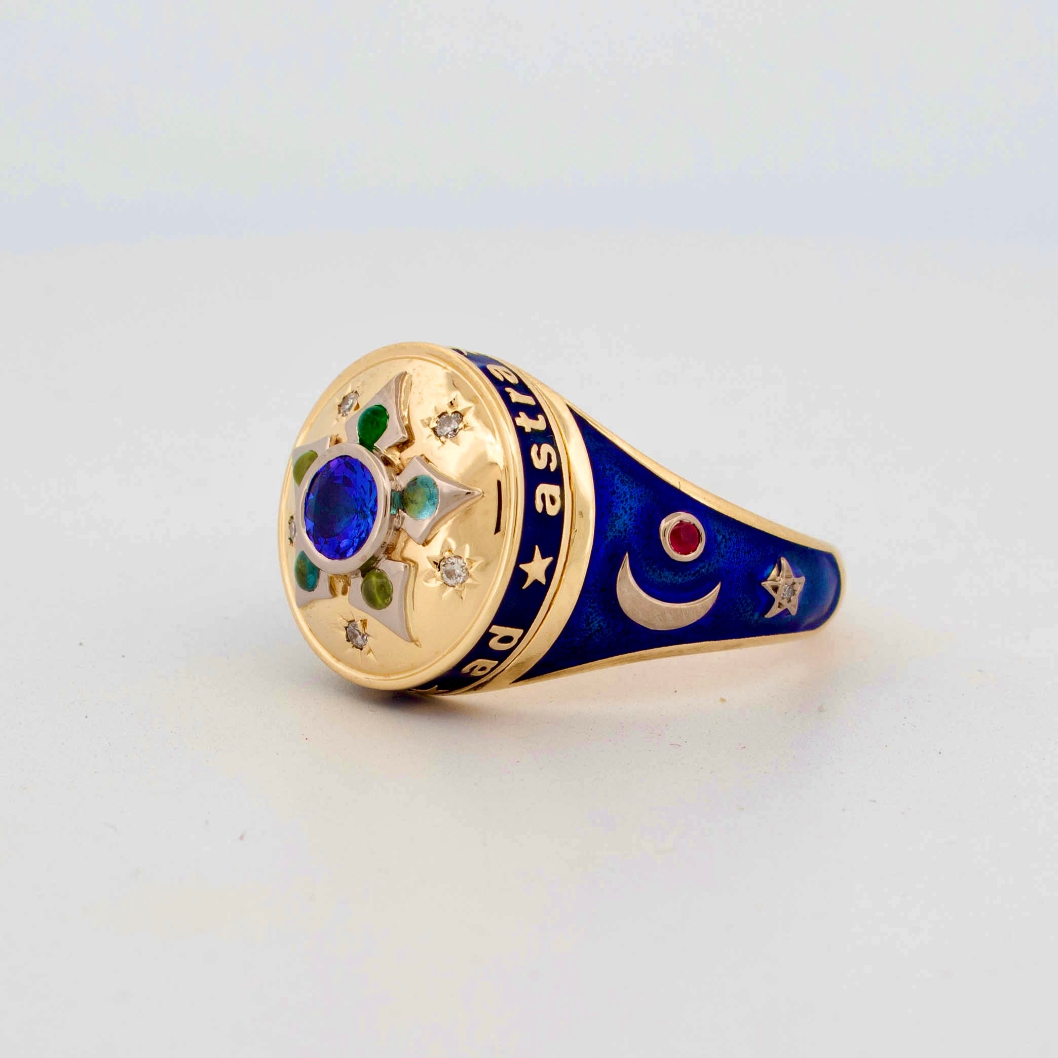18ct yellow gold mourning-style ring inspired by Victorian jewellery, featuring a central deep blue enamel disc surrounded by family birthstones and star-set diamonds in a radial motif, with navy enamelled shoulders and the engraved motto 'Per Aspera Ad Astra'