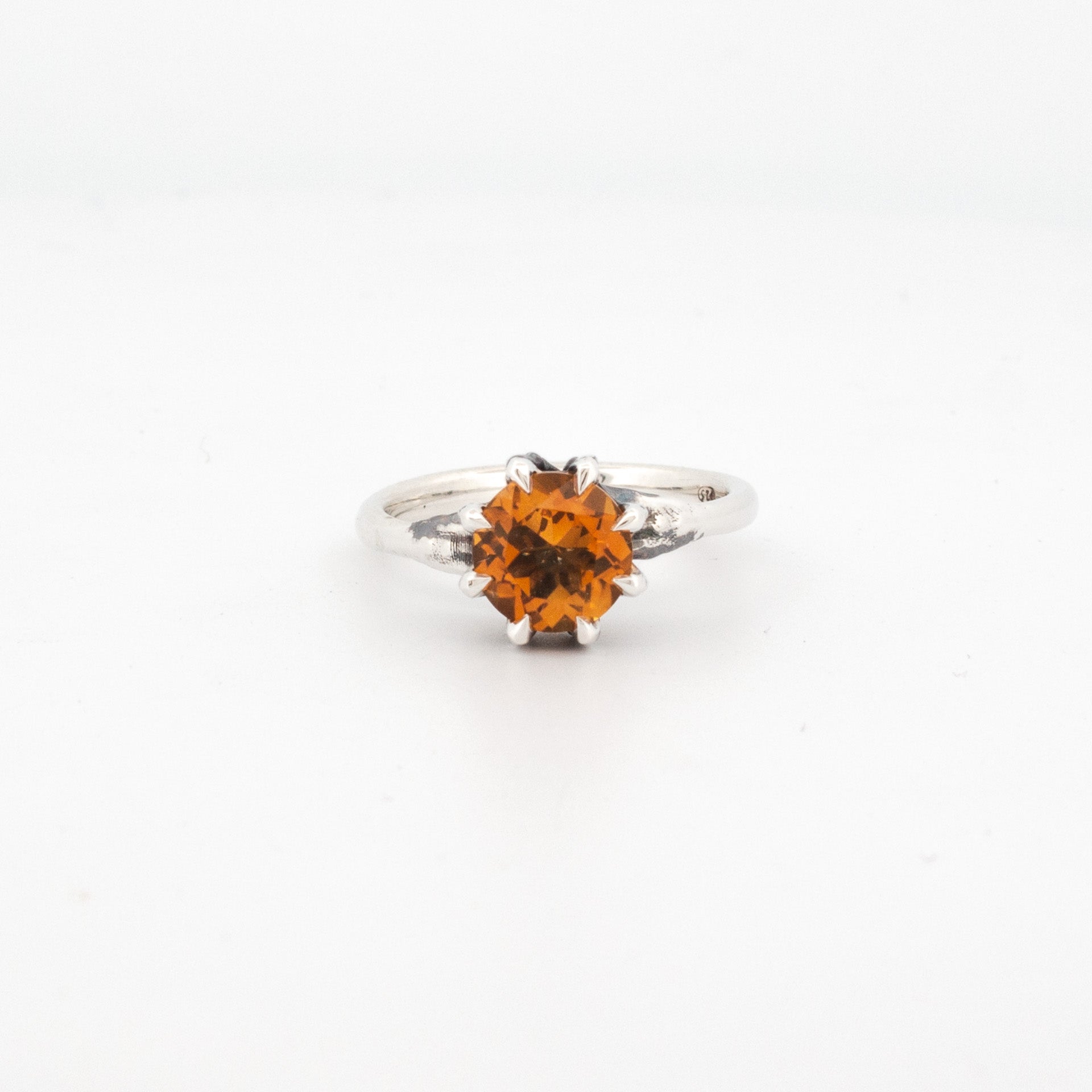 8mm round citrine claw-set in sterling silver talon-style setting with textured silver band.