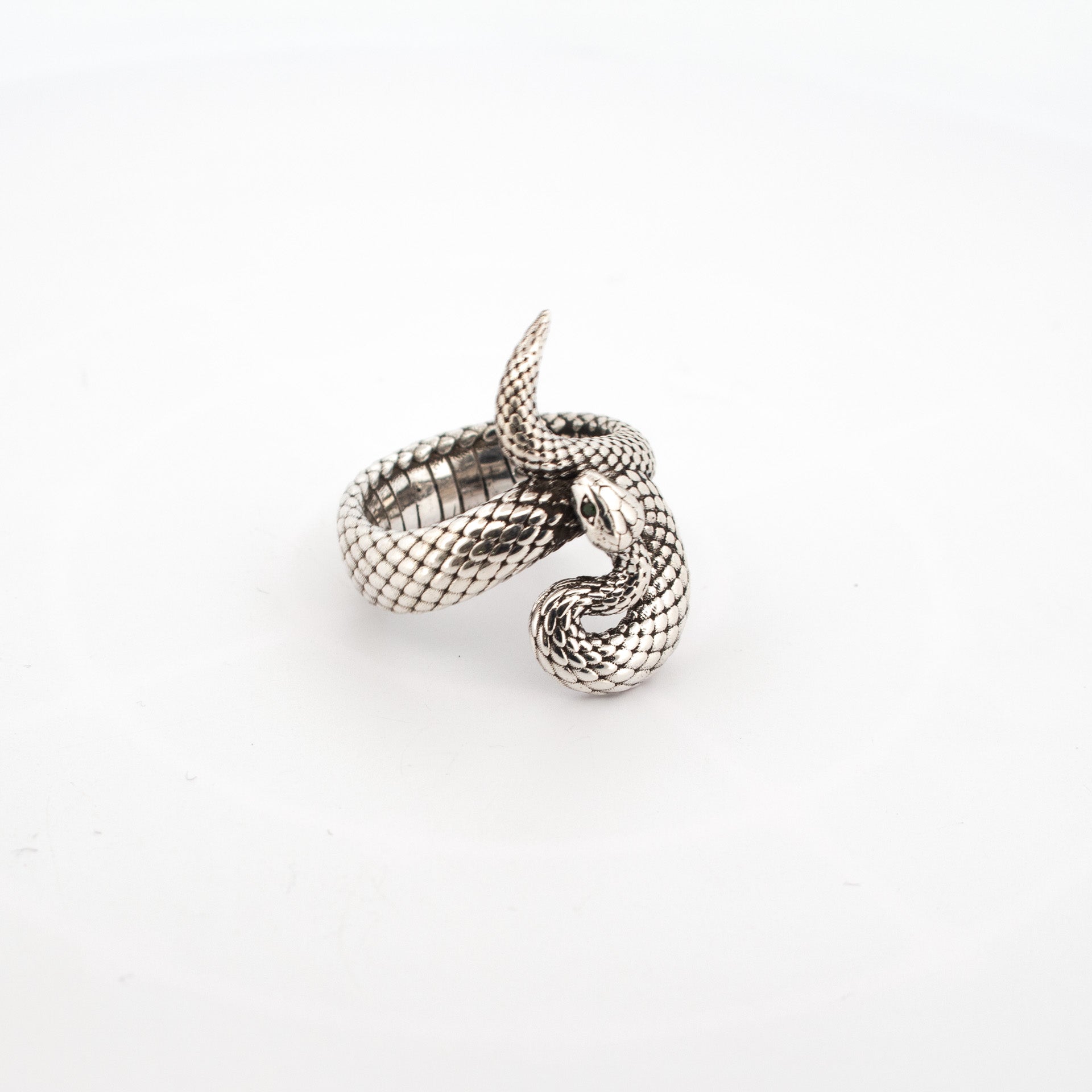 Sterling Silver Snake Ring with detailed scales and ruby gemstone eyes, coiled serpent design, handmade silver jewellery.