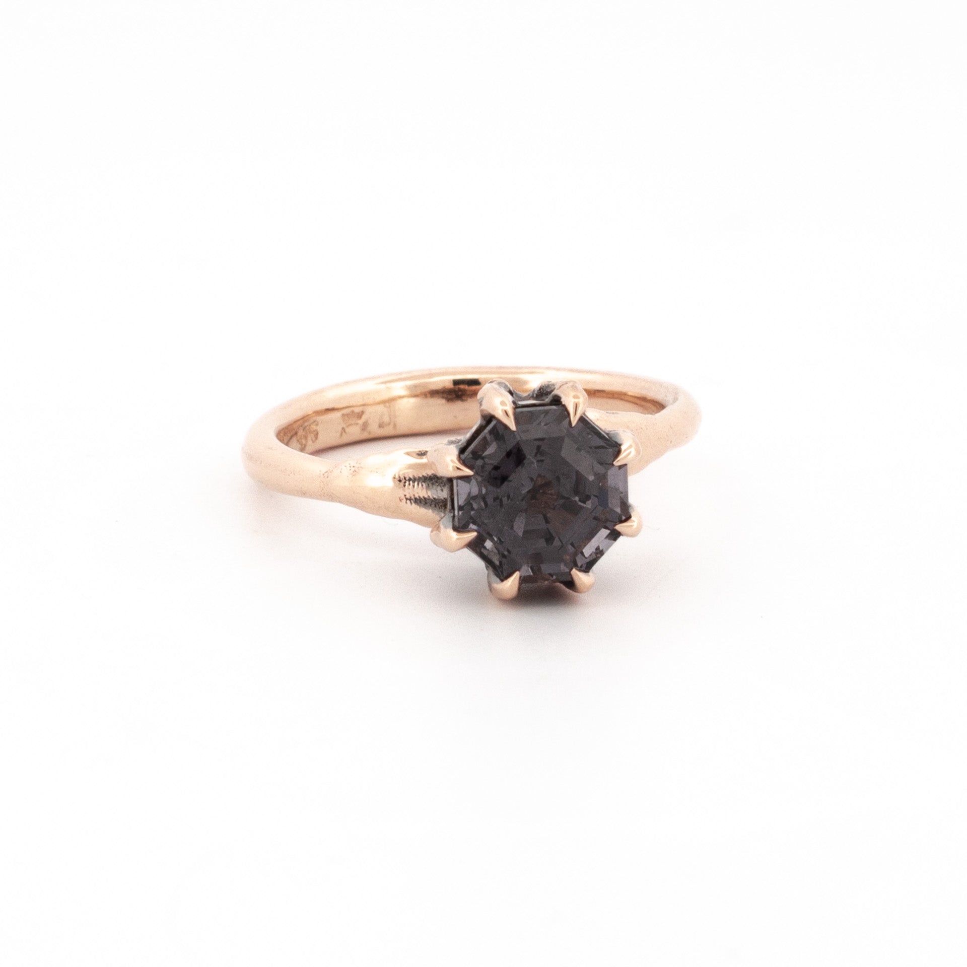 9ct rose gold ring with octagonal purple-grey spinel in claw talon setting.
