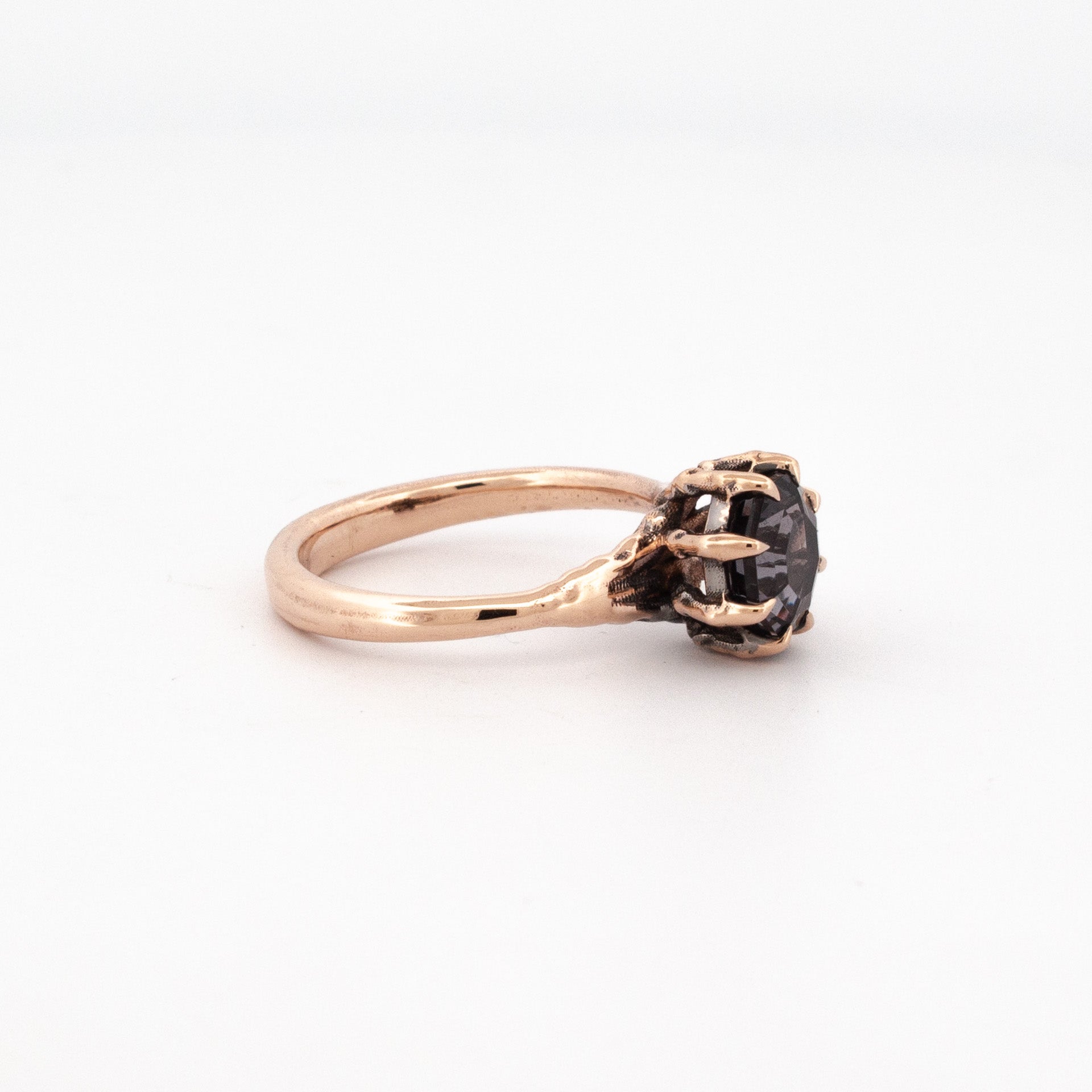 9ct rose gold ring with octagonal purple-grey spinel in claw talon setting.