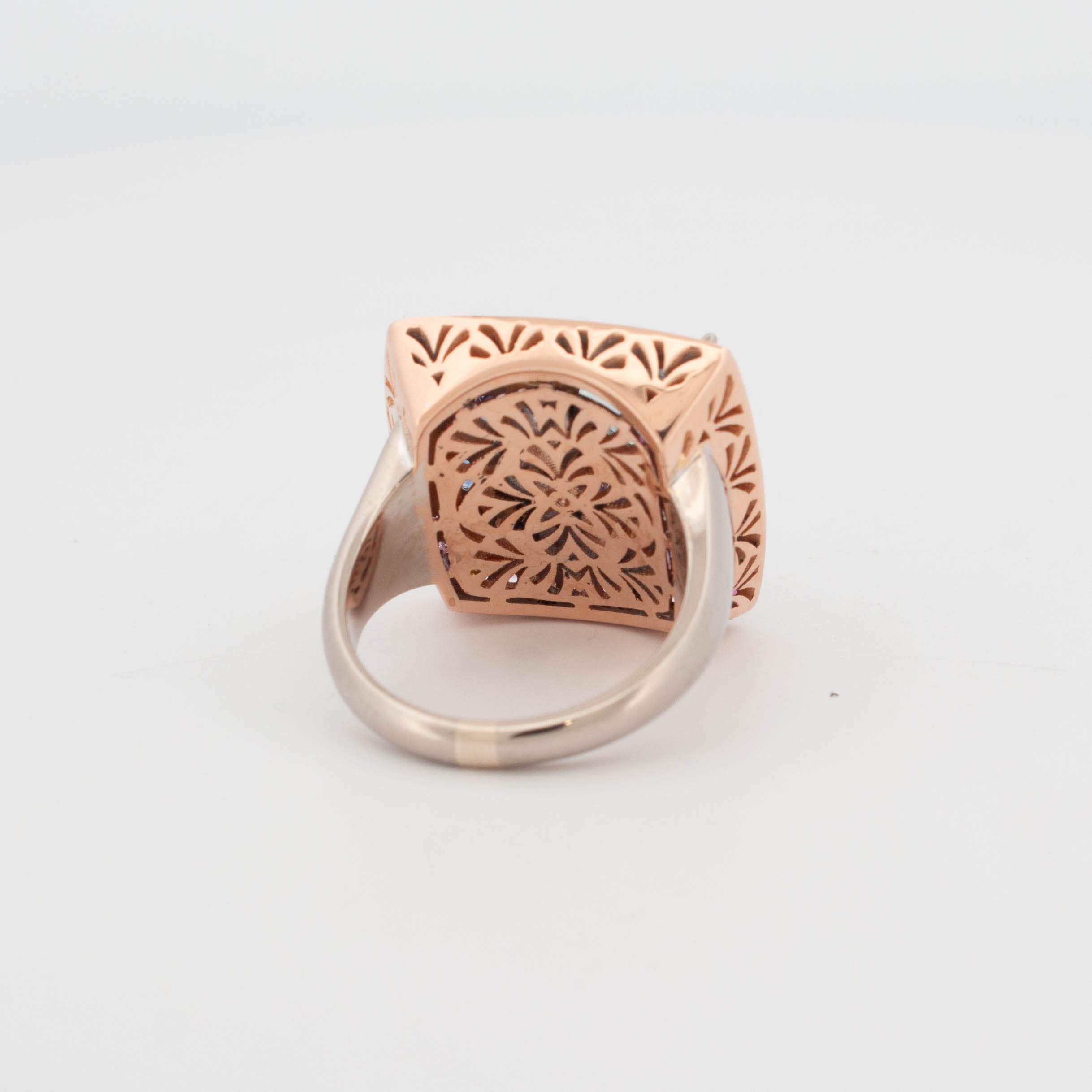 Handmade 18ct rose, white, and yellow gold ring featuring central aquamarine in geometric cut, tanzanite in triangular cuts, round brilliant cut diamonds in yellow gold bezels, and pavé-set colour fade sapphires transitioning from pink to blue.