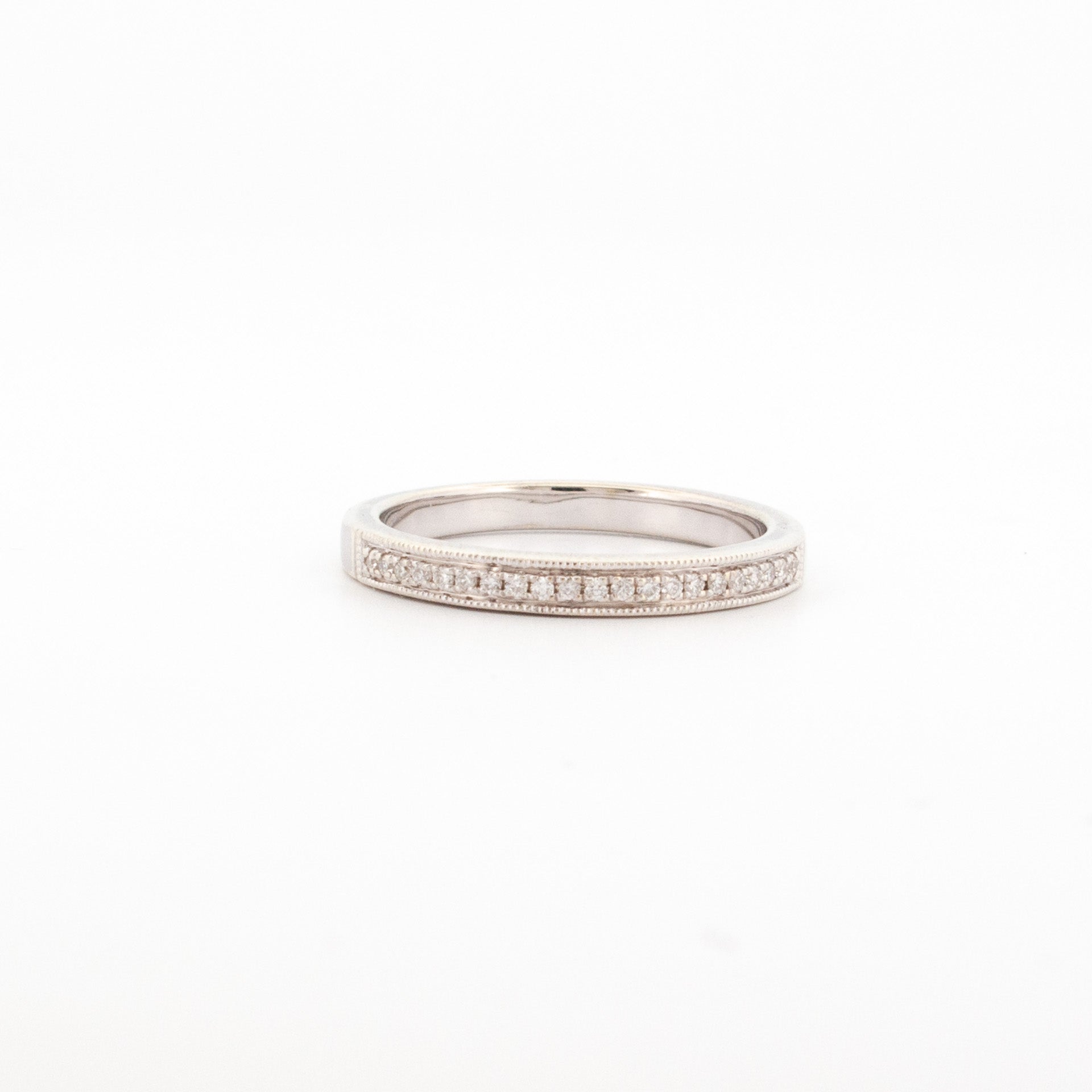 9ct white gold ring featuring a single row of round white diamonds in a bead setting with milgrain edge detailing.