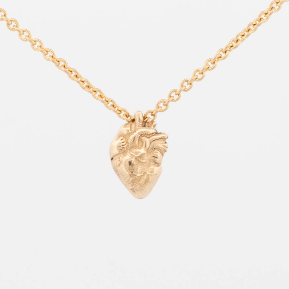 8mm anatomical heart pendant in 9ct yellow gold on fine chain with detailed organic engraving.