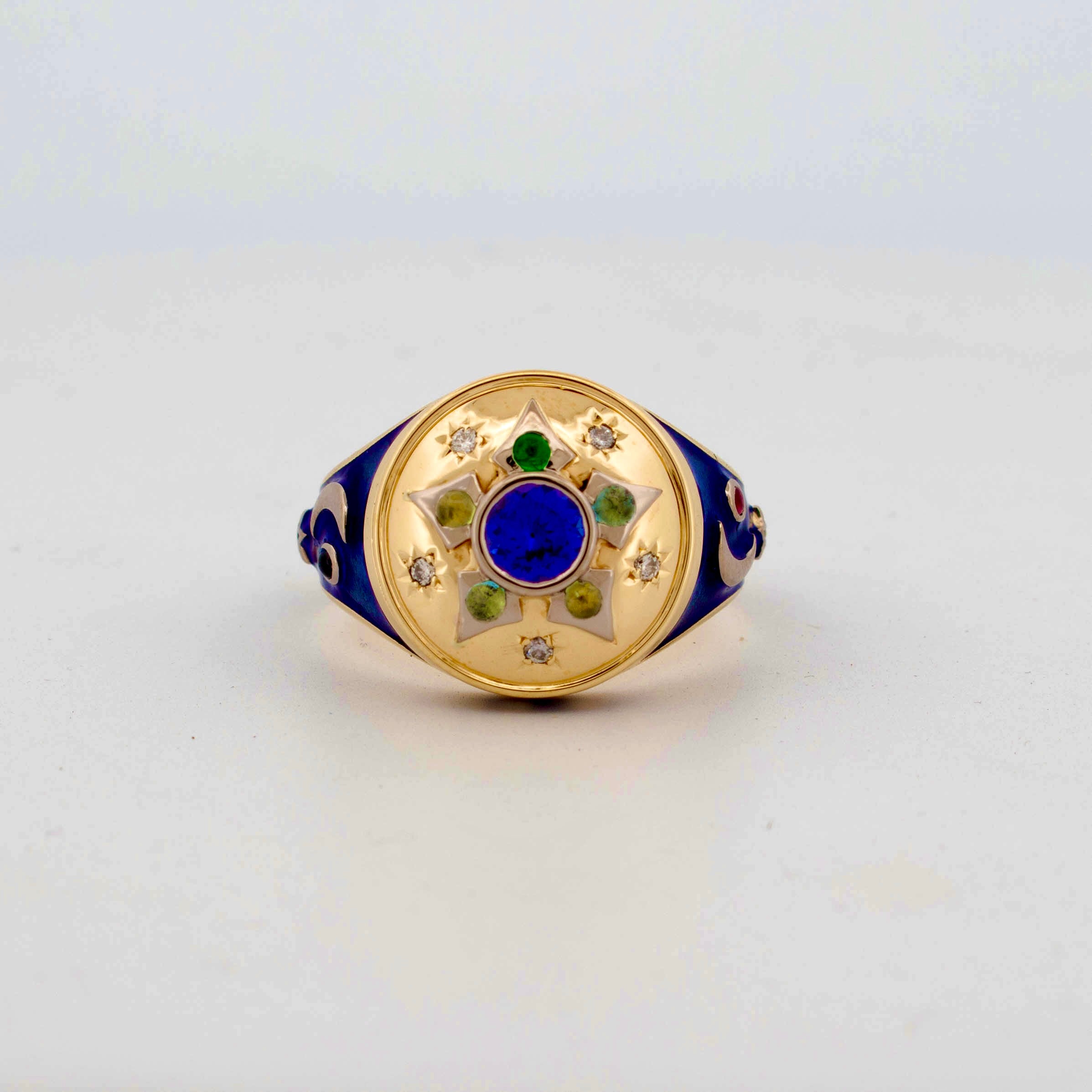 18ct yellow gold mourning-style ring inspired by Victorian jewellery, featuring a central deep blue enamel disc surrounded by family birthstones and star-set diamonds in a radial motif, with navy enamelled shoulders and the engraved motto 'Per Aspera Ad Astra'