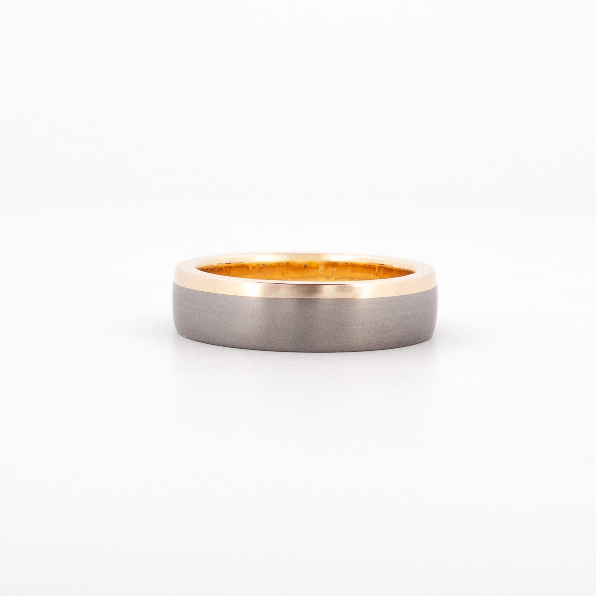 Flat-profile ring featuring a matte grey tantalum exterior and polished 9ct yellow gold inner band.