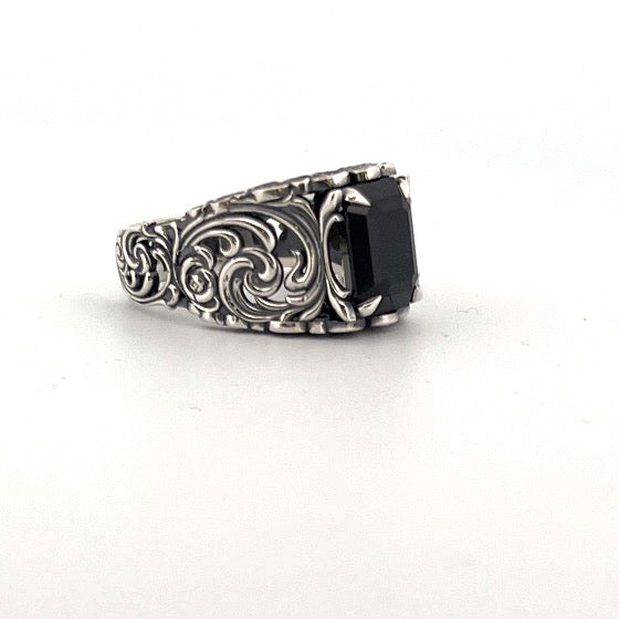 Sterling silver ring with emerald-cut black spinel and ornate scrollwork band.