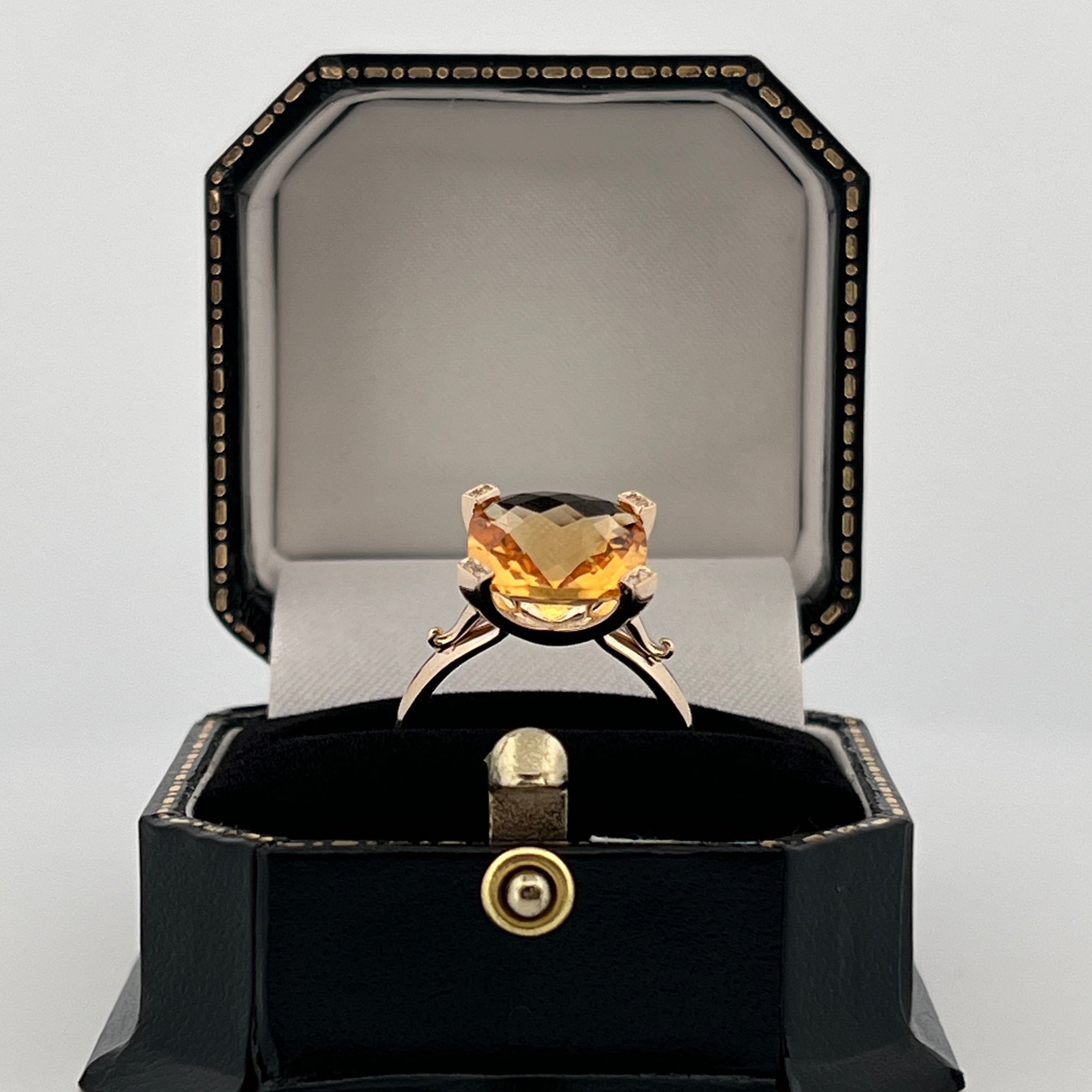 9ct yellow gold ring with 10mm cushion-cut checkerboard citrine and diamond-set claw tips.