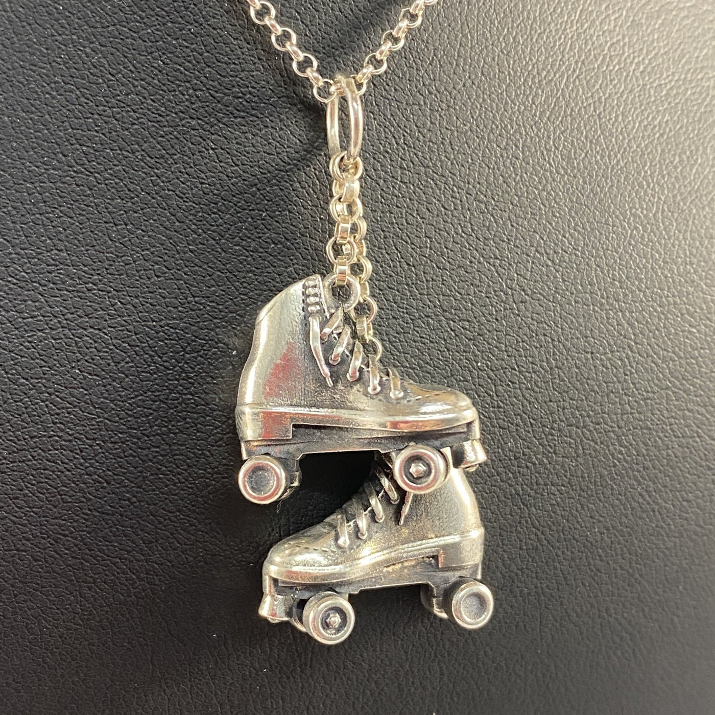 Sterling silver roller skate pendant with detailed laces and wheels on fine chain