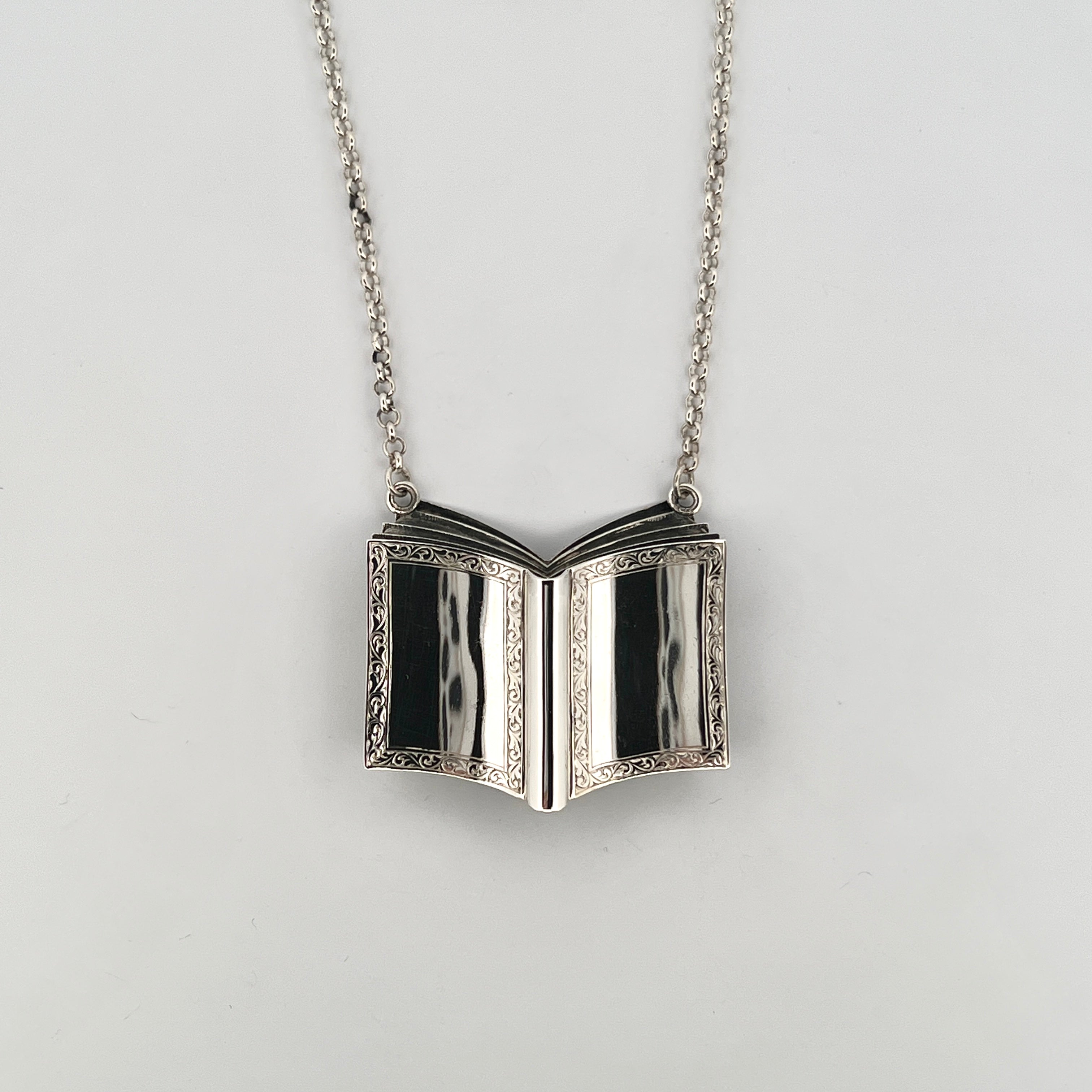 Sterling silver open book pendant necklace with engraved pages on fine silver chain