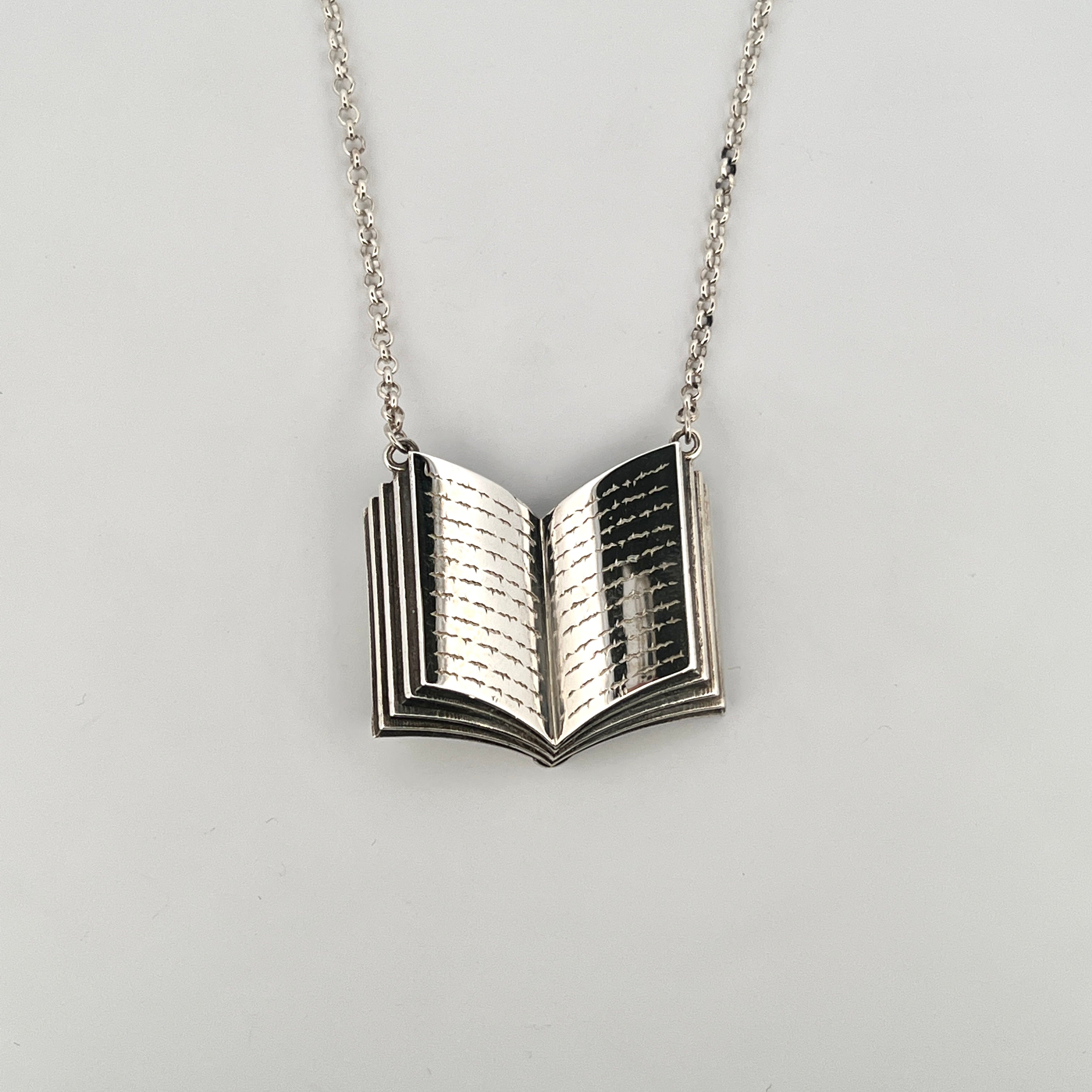 Sterling silver open book pendant necklace with engraved pages on fine silver chain