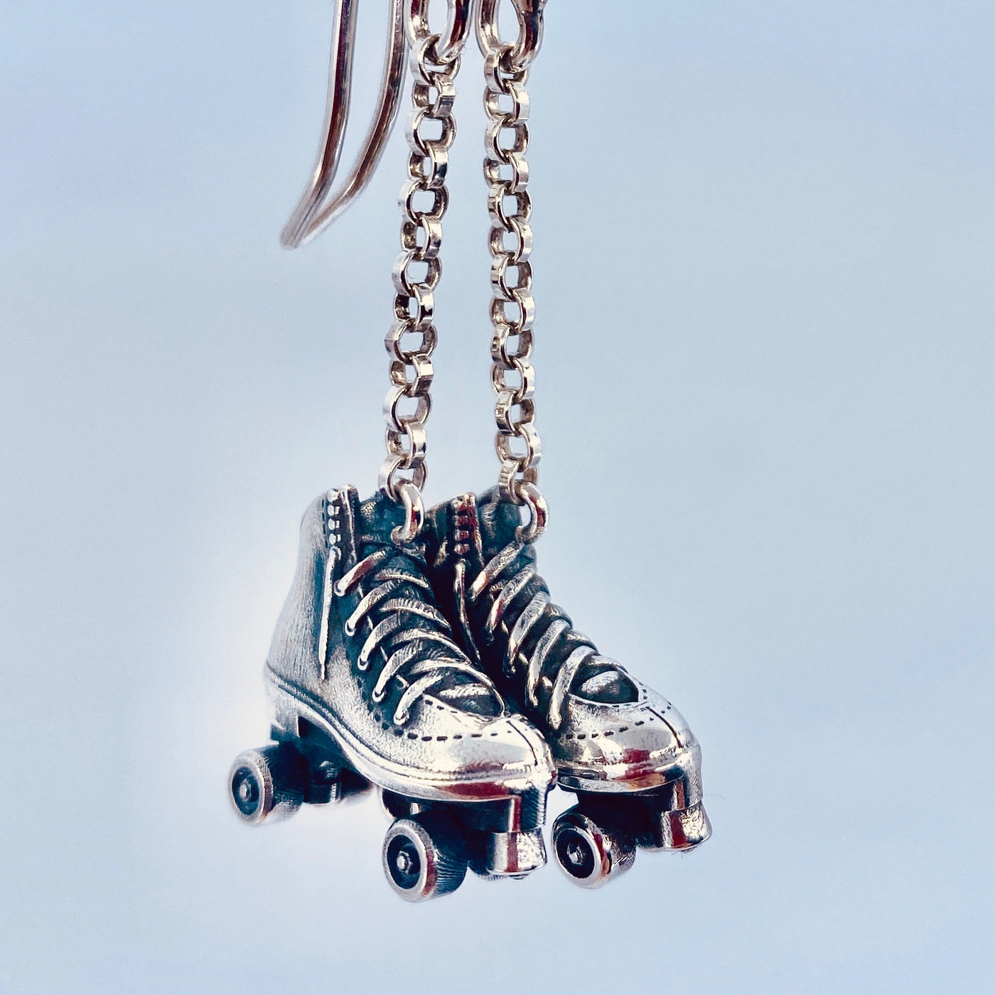 Sterling Silver Roller Skate Earrings with chain drops, detailed lace-up boot design and miniature wheels, handmade silver jewellery.