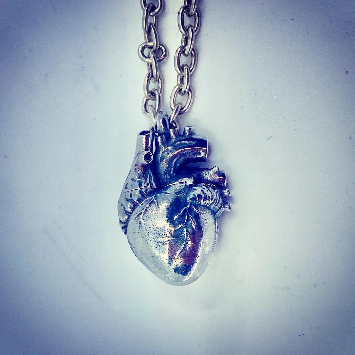 Sterling silver anatomical heart pendant necklace with fine detail on chain