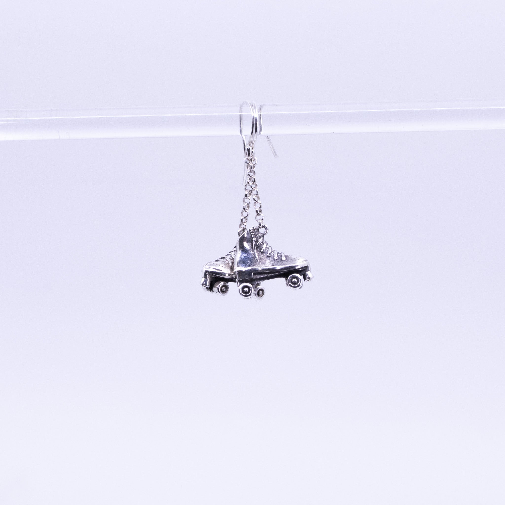 Sterling Silver Roller Skate Earrings with chain drops, detailed lace-up boot design and miniature wheels, handmade silver jewellery.