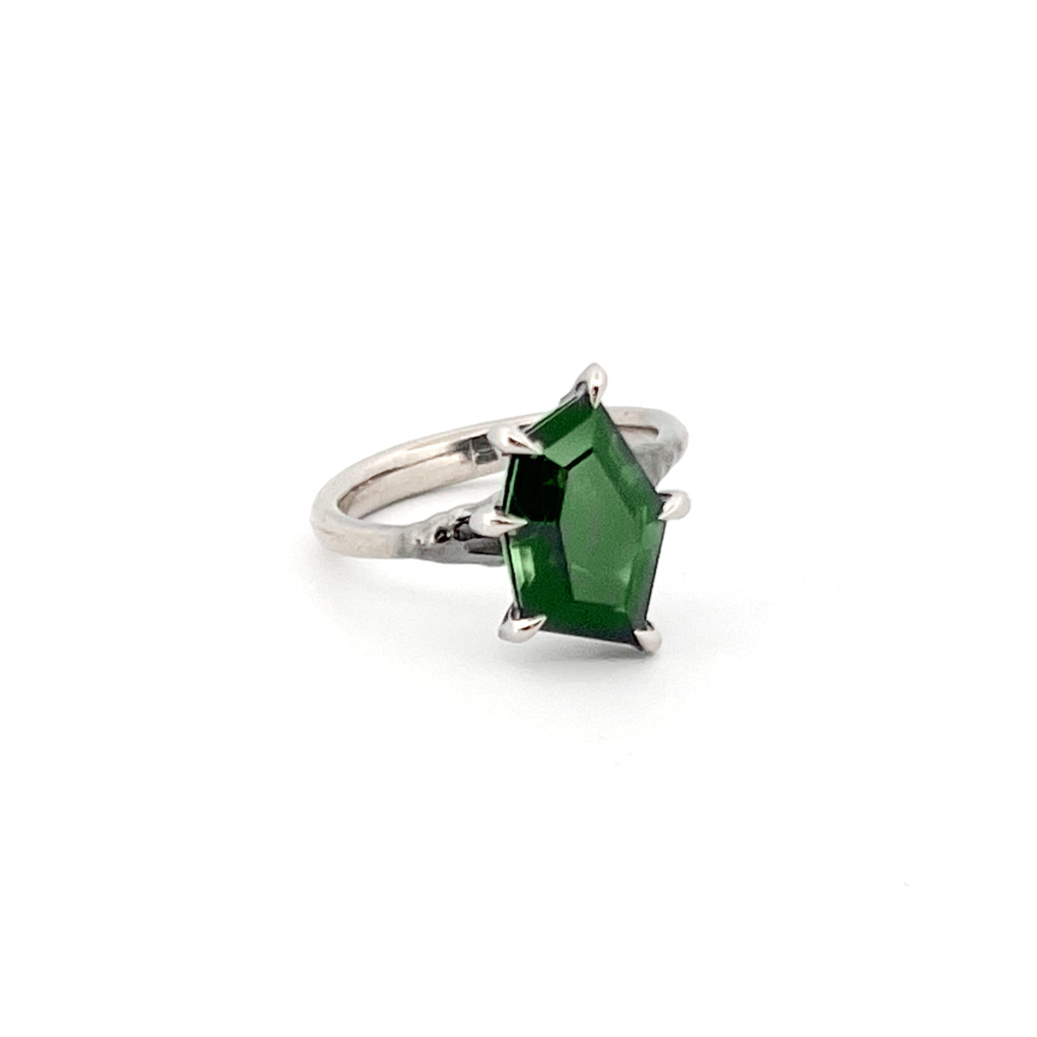18ct White gold ring with shield-cut green tourmaline in six-claw setting, featuring geometric faceted design and polished band.