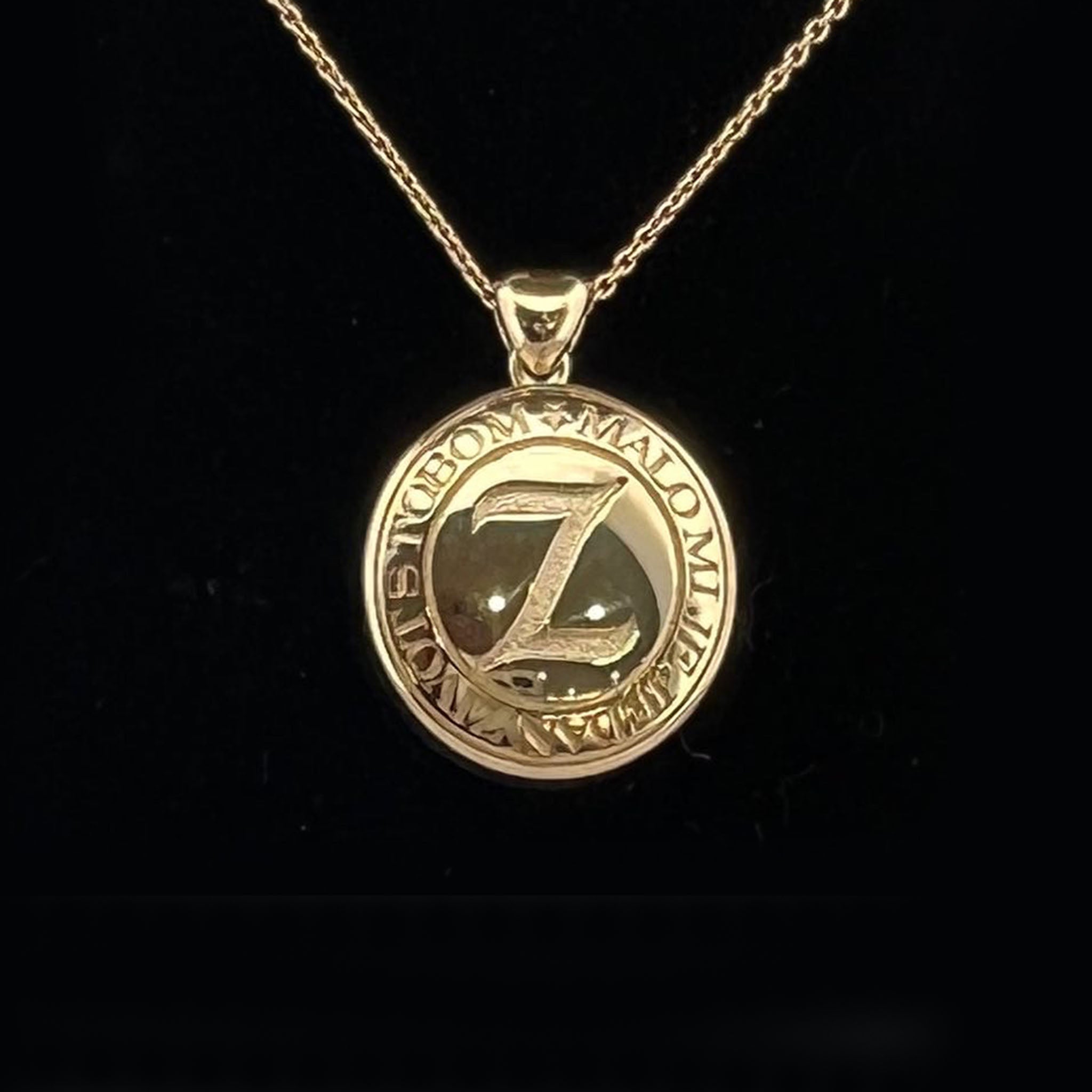 18ct yellow and white gold memorial pendant with hidden compartment for ashes, front featuring raised star with central diamond, reverse engraved with “Z” and song words with musical notation.