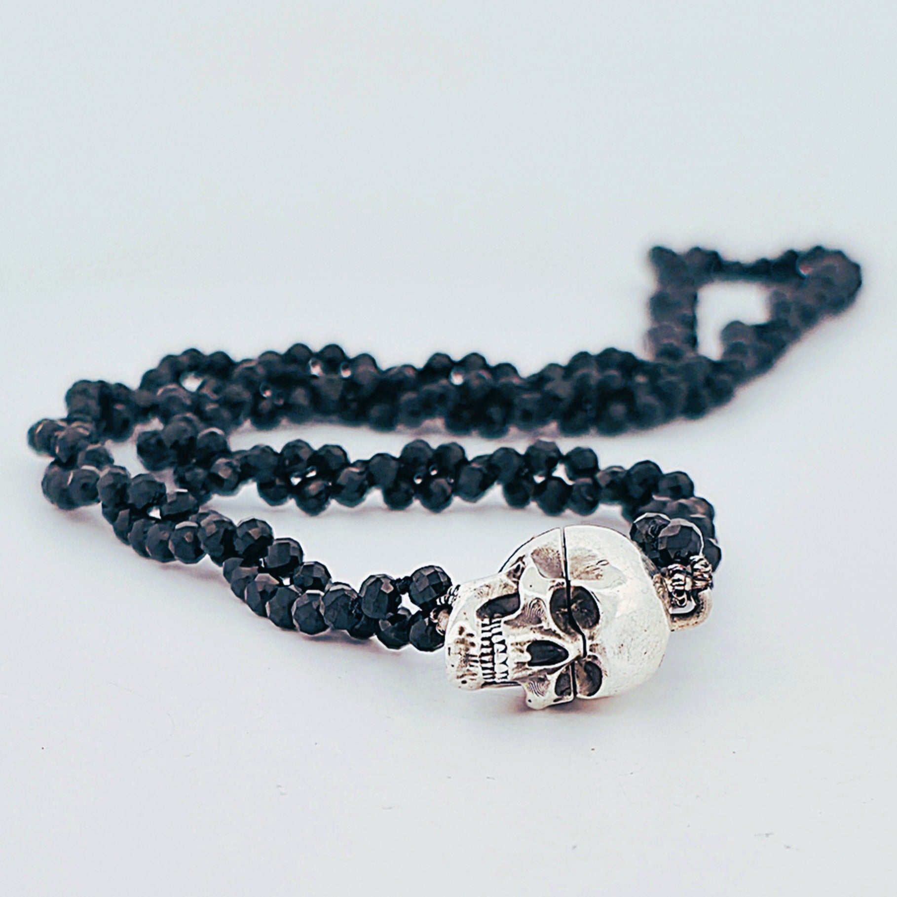 Sterling silver deep sea mine pendant with oxidised finish and magnetic clasp, suspended from a double strand of faceted black spinel beads; handcrafted statement necklace