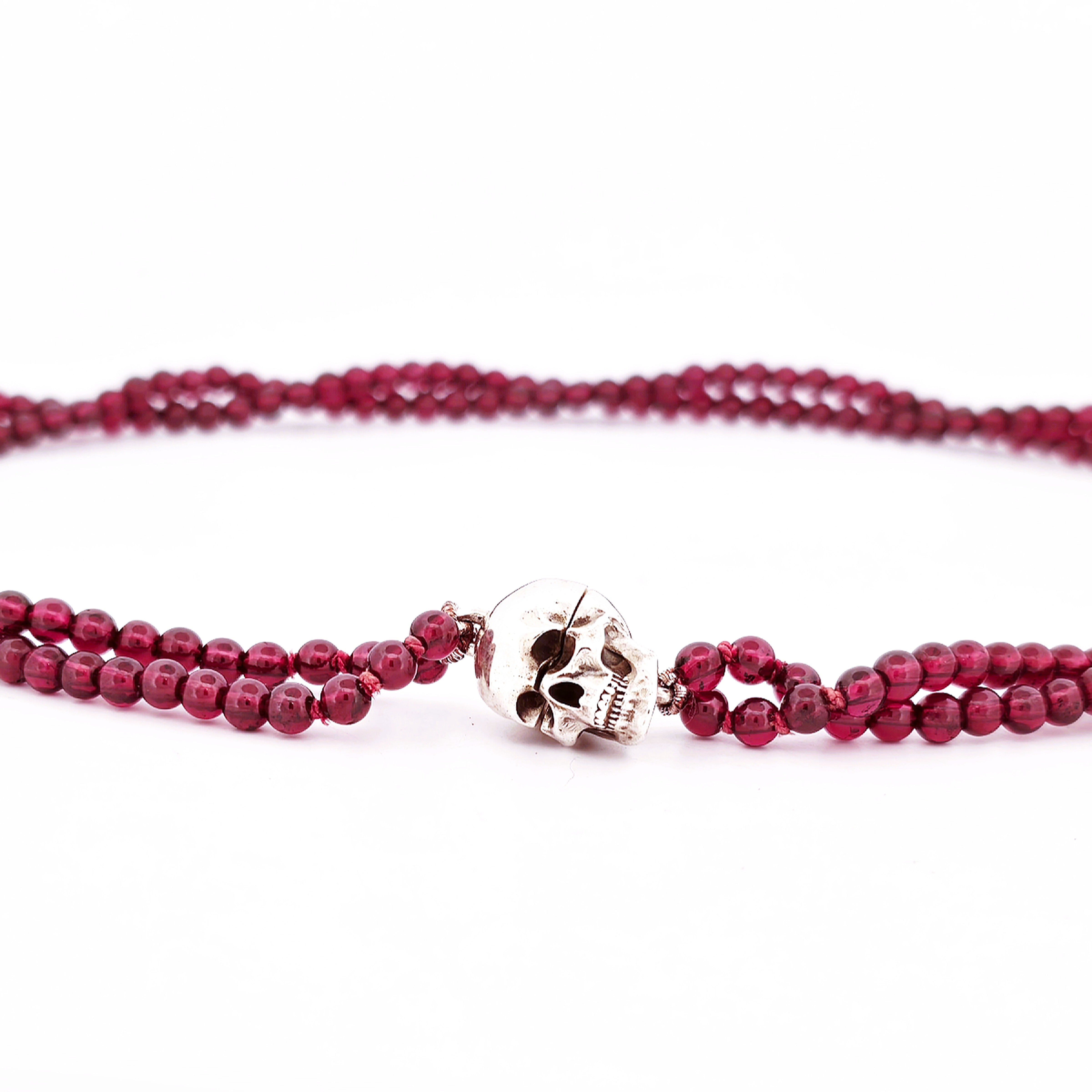Silver magnetic skull pendant on a garnet strand necklace