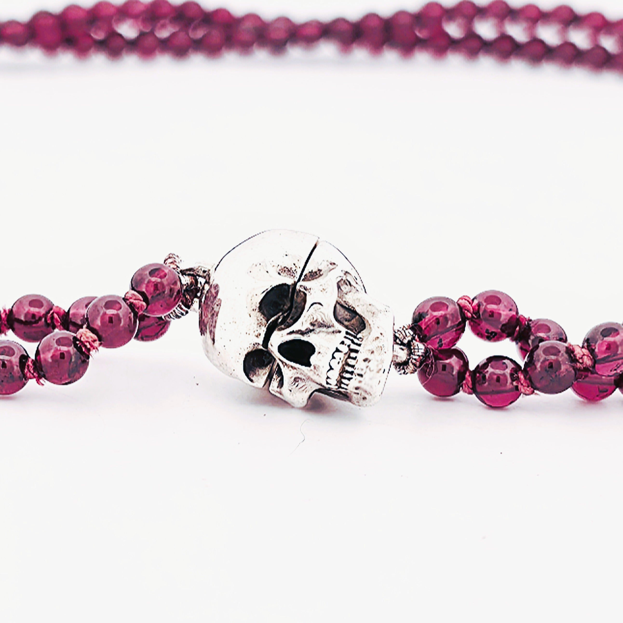 Silver magnetic skull pendant on a garnet strand necklace