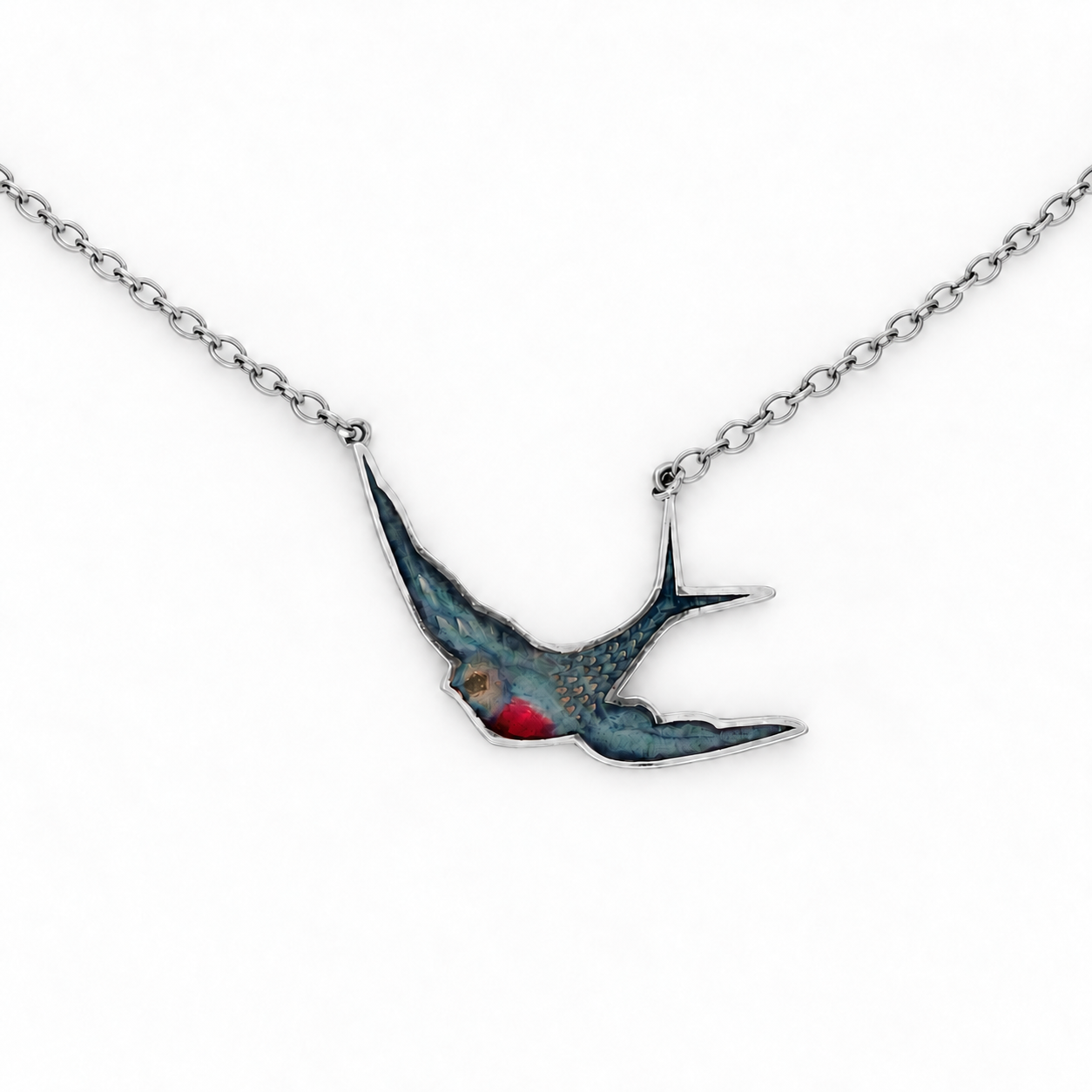 Enamel Swallow Necklace in sterling silver featuring a stylised flying swallow pendant with blue and red enamel detailing, suspended on a fine paperclip-style chain.