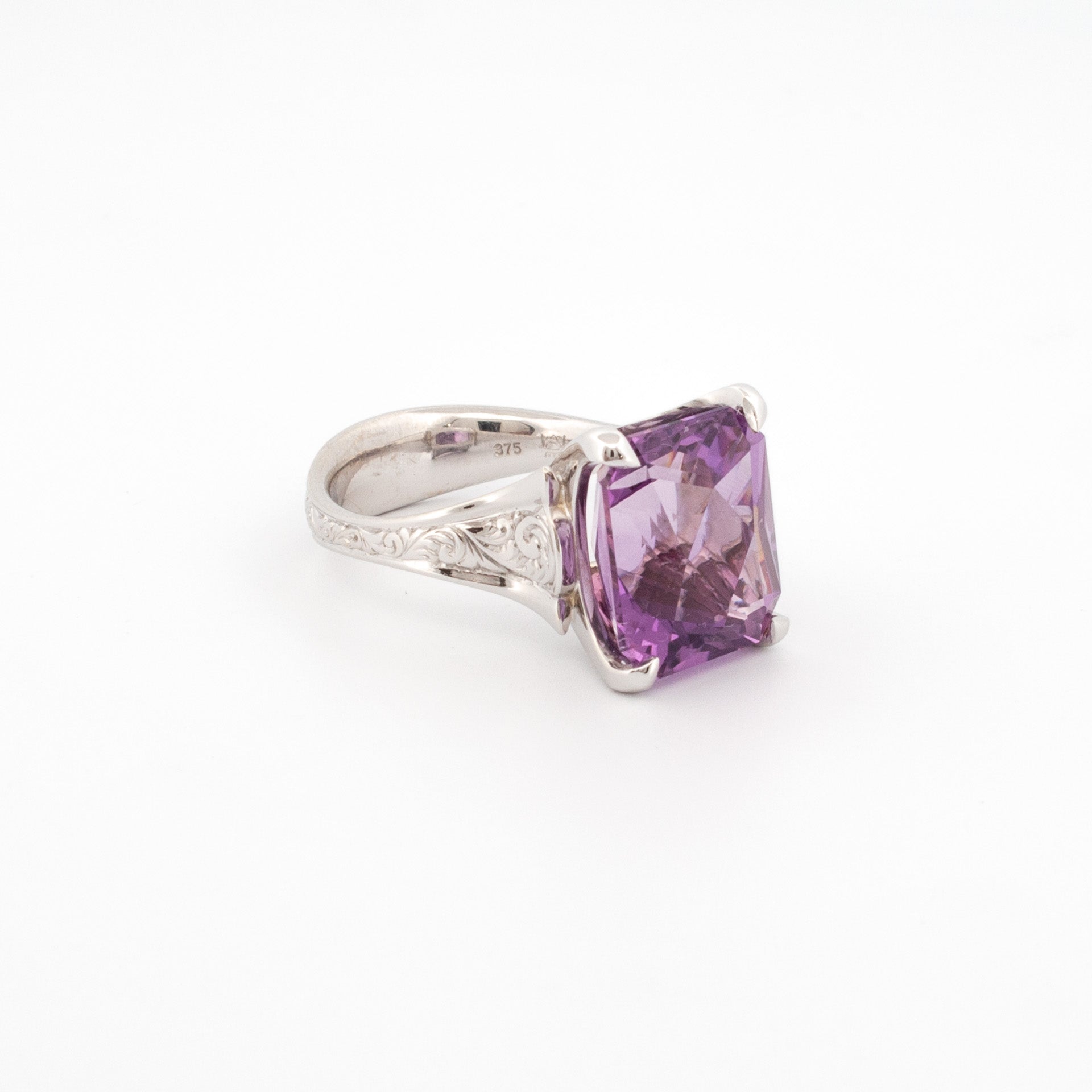 Custom cut rectangular amethyst ring in 9ct white gold with hand engraved scroll detail, claw set statement gemstone