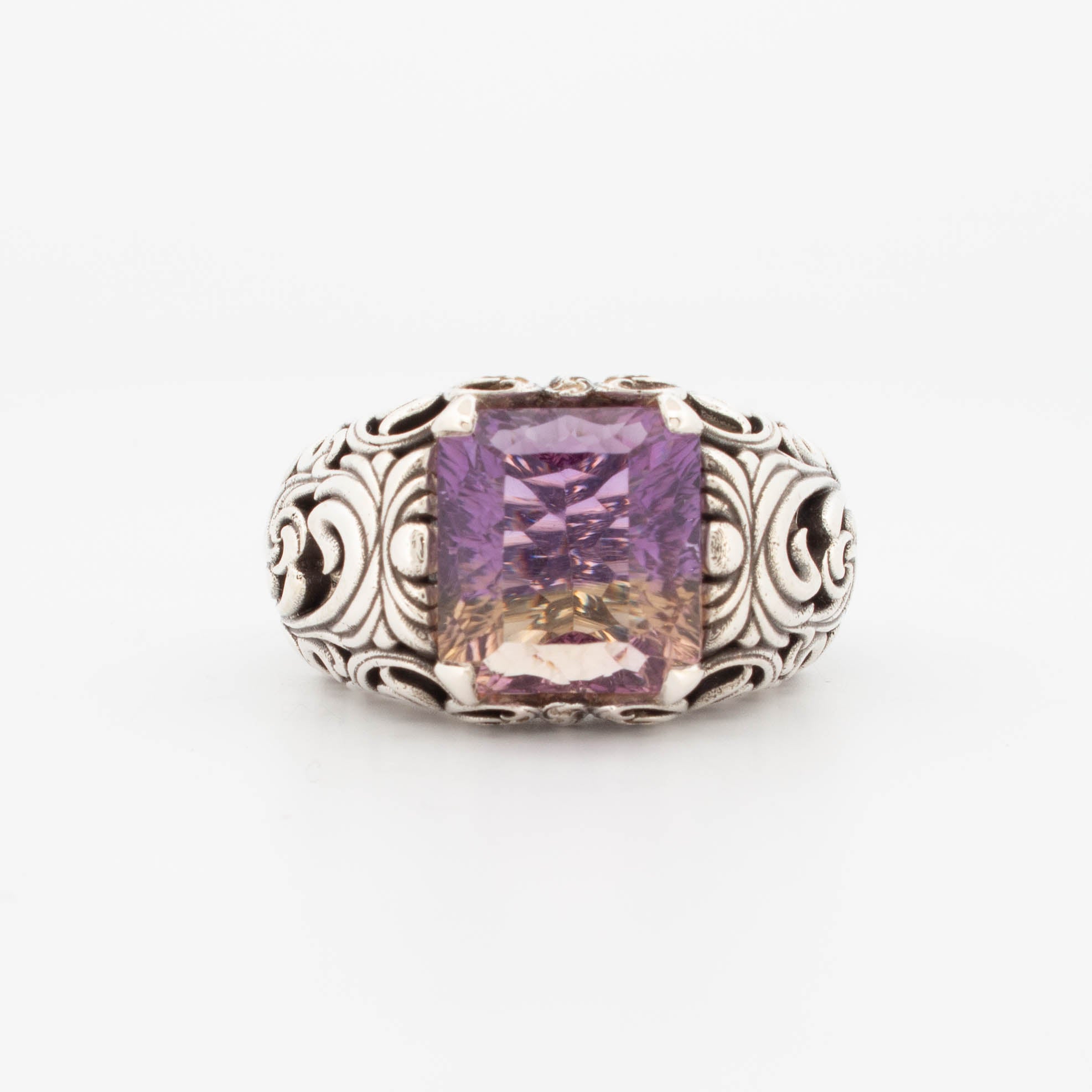 Sterling silver ametrine ring featuring a large emerald-cut gemstone with a natural gradient from purple to golden yellow. The high-detail band showcases ornate scrollwork and filigree patterns, adding a vintage, baroque-inspired elegance. Ideal for lovers of unique, bold gemstone rings and statement silver jewellery.