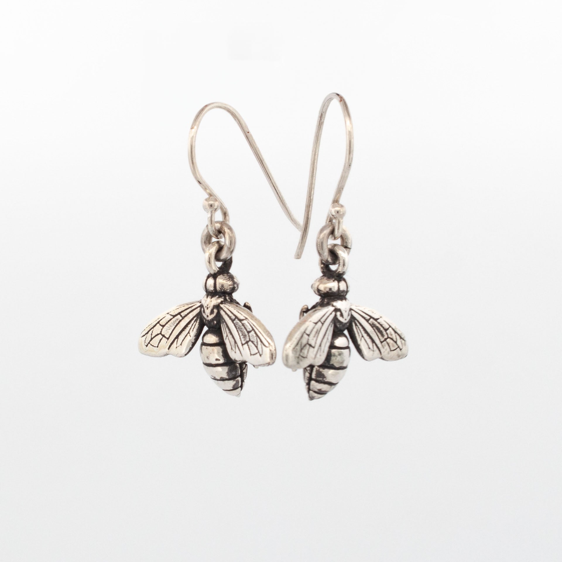 Oxidised sterling silver bee earrings with detailed wings and bodies on drop shepherd hooks.
