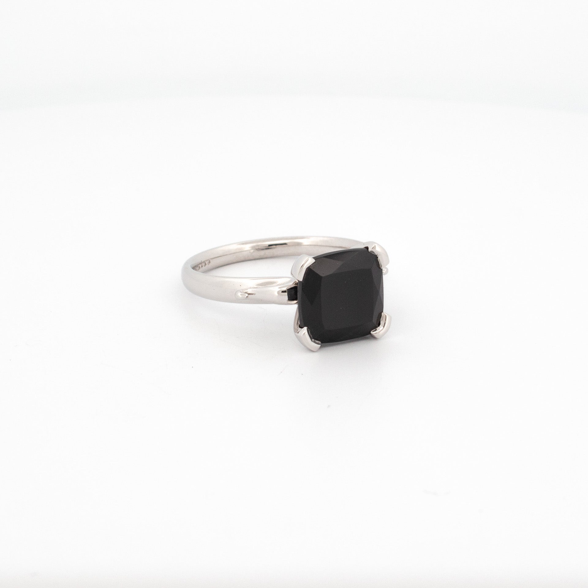 9ct white gold ring with cushion cut black spinel, four claw setting, polished band, handmade solitaire design