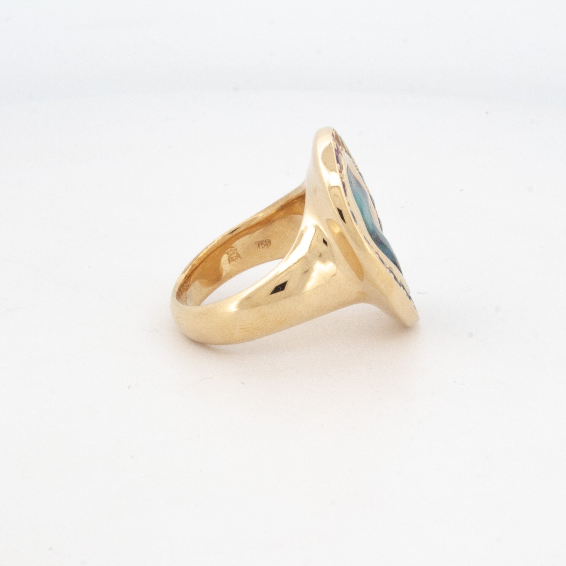 18ct yellow gold ring featuring boulder opal centre stone surrounded by rainbow-hued sapphires in oval bezel setting.