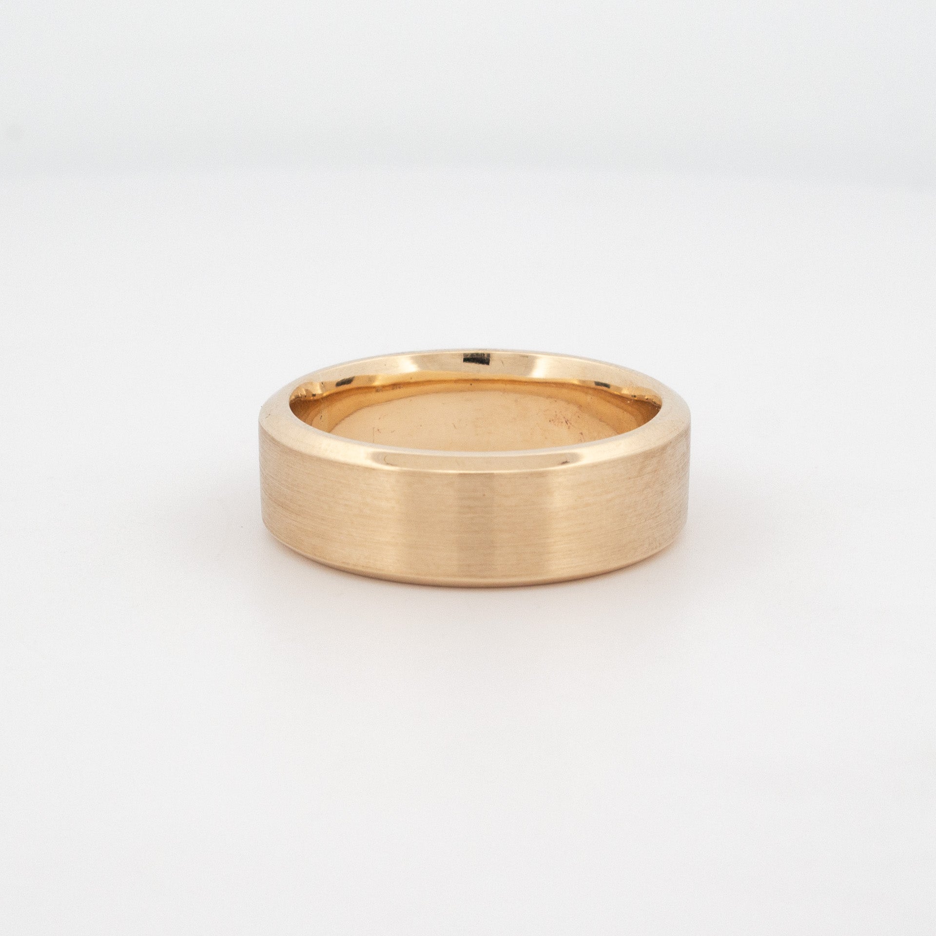A classic matte finish wedding band in 9ct yellow gold with a flat profile and chamfered edge.