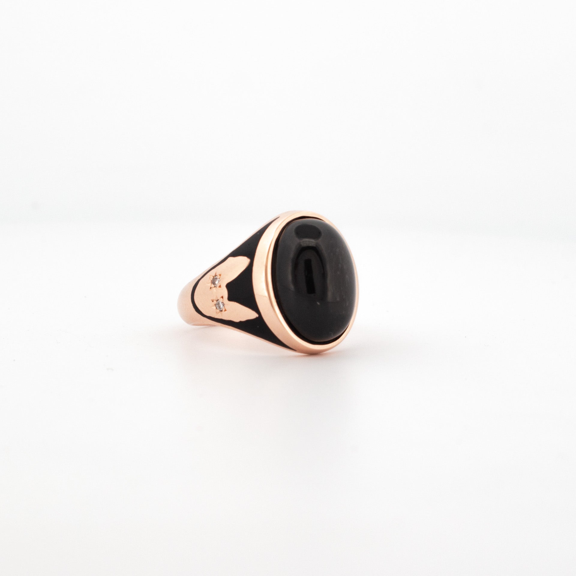 Rose gold ring featuring high-domed black cabochon with enamel detailing and Cornish Rex cat motif set with diamonds.