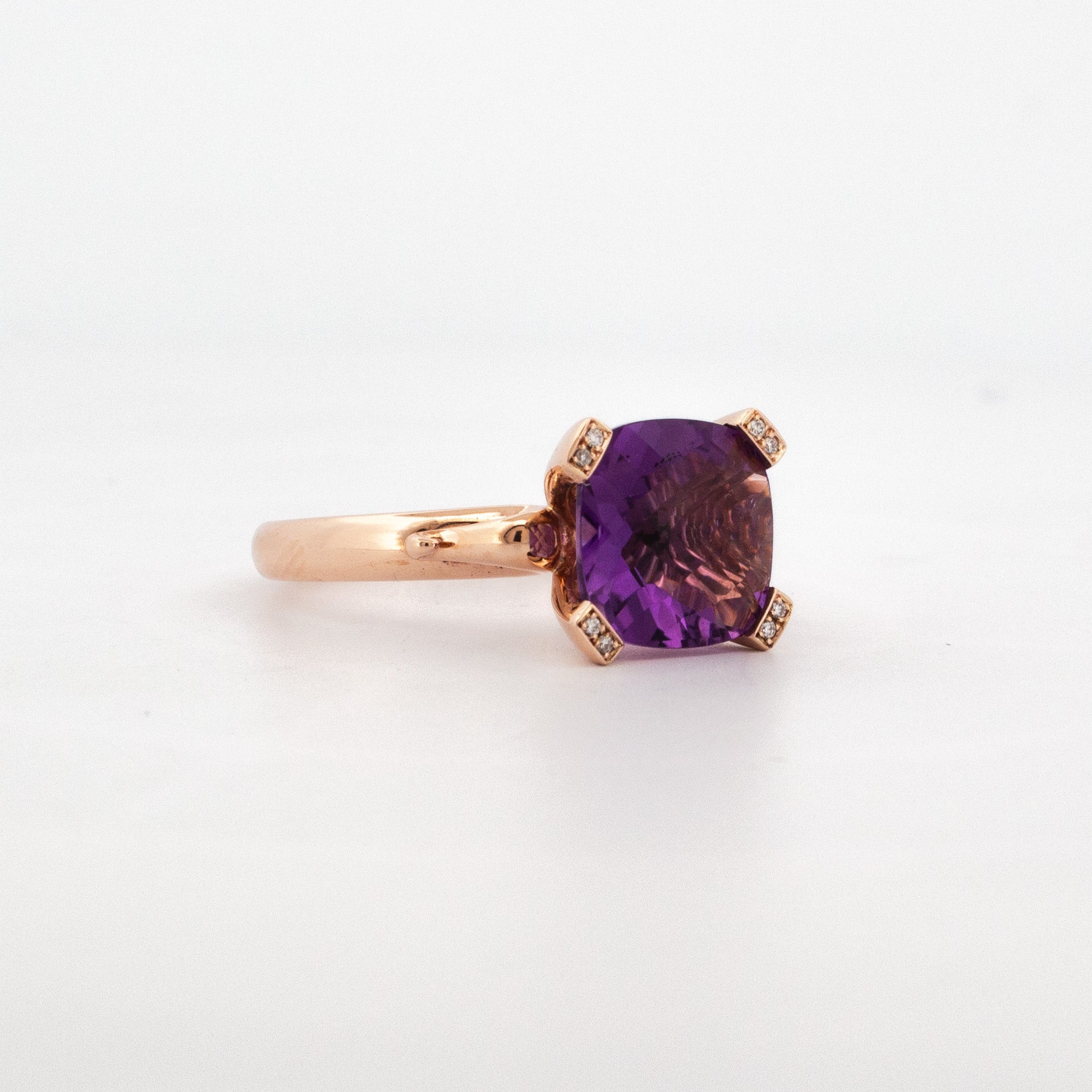 9ct rose gold ring with 10mm cushion-cut amethyst and diamond-set claw prongs.