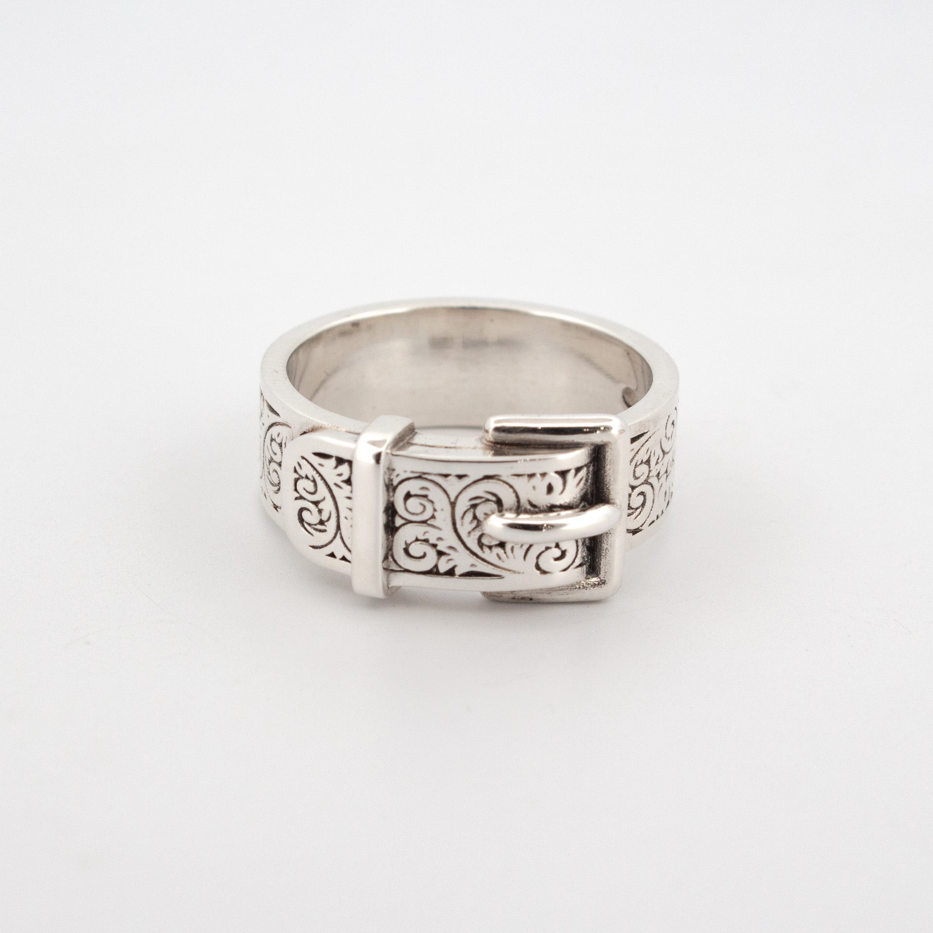 Sterling silver buckle ring with engraved scrollwork pattern and raised buckle detail.