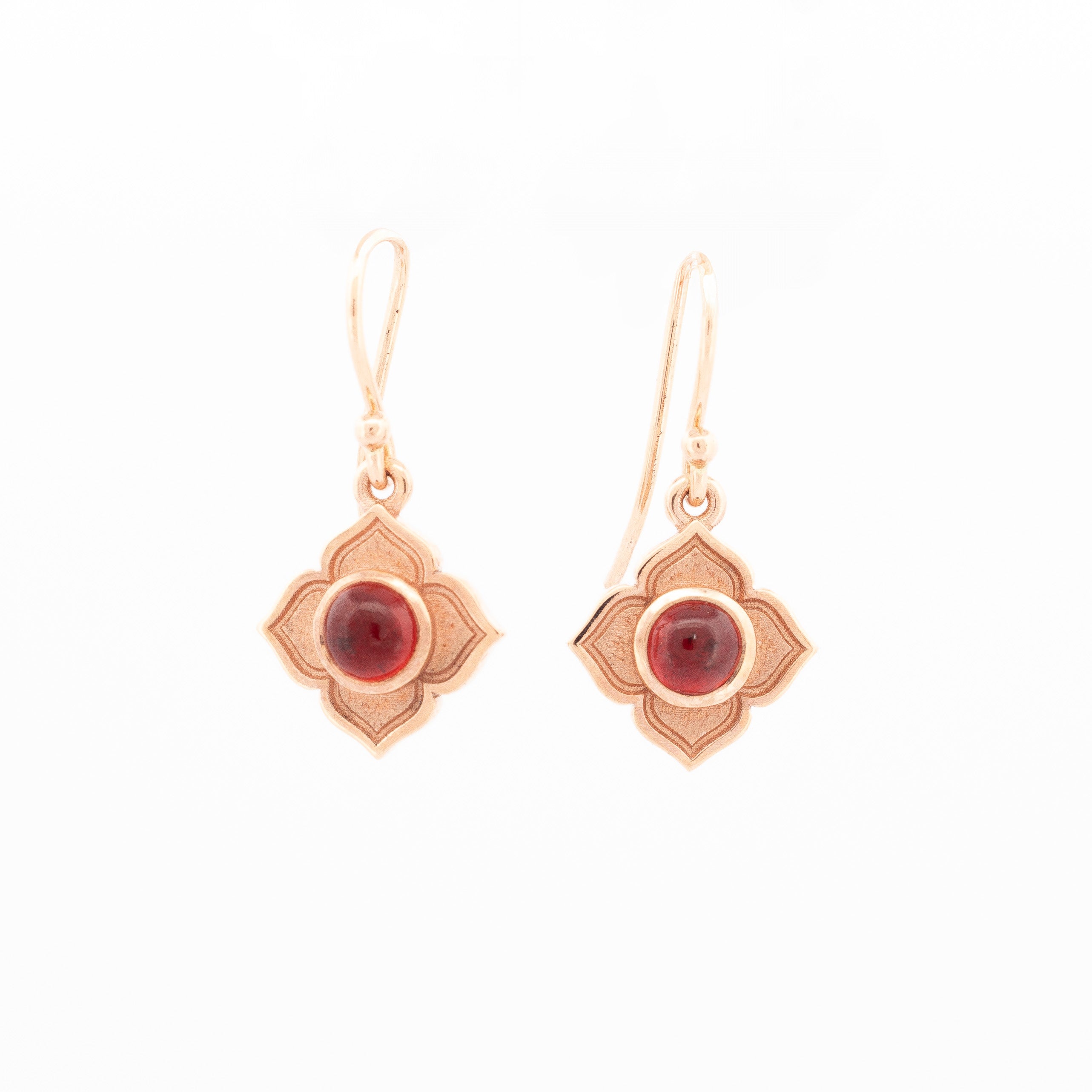 Pair of drop earrings featuring round cabochon garnets set in floral-shaped 9ct rose gold mounts with matte and polished finish.
