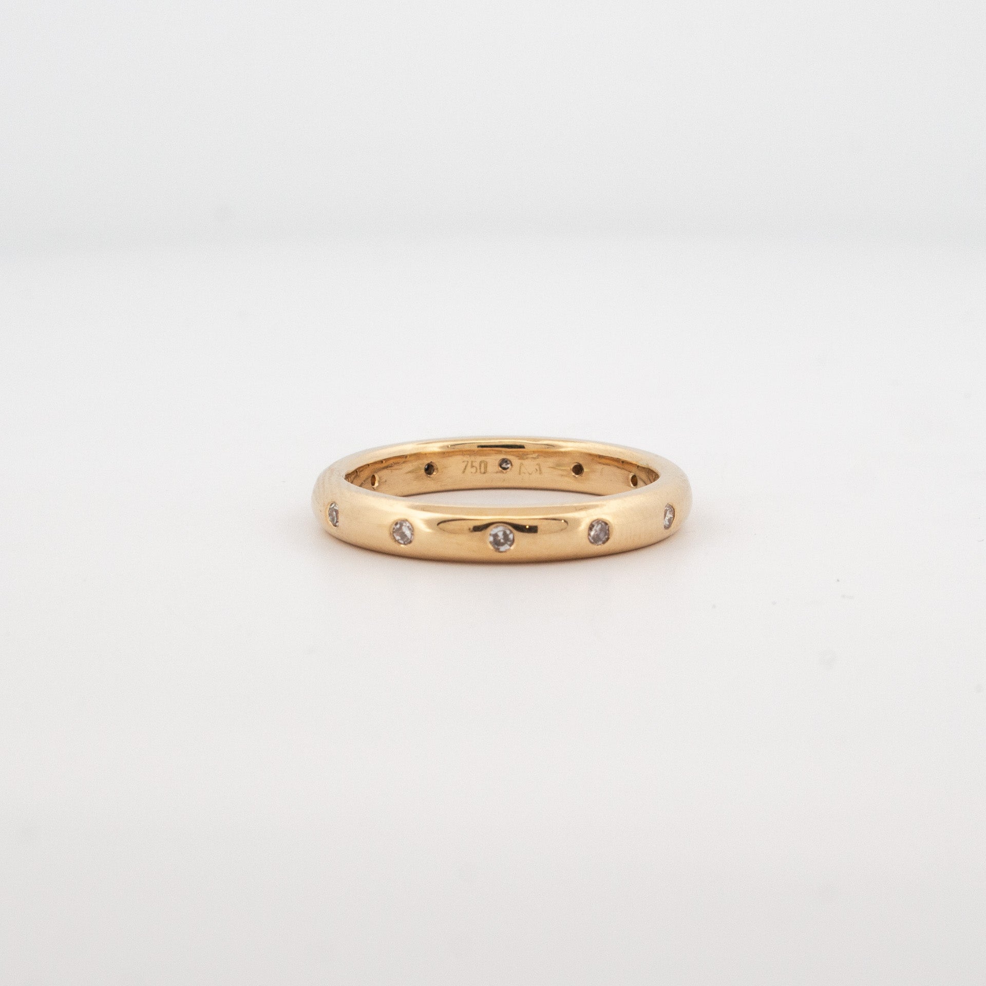 18ct yellow gold wedding ring with evenly spaced gypsy set round diamonds, classic low dome profile